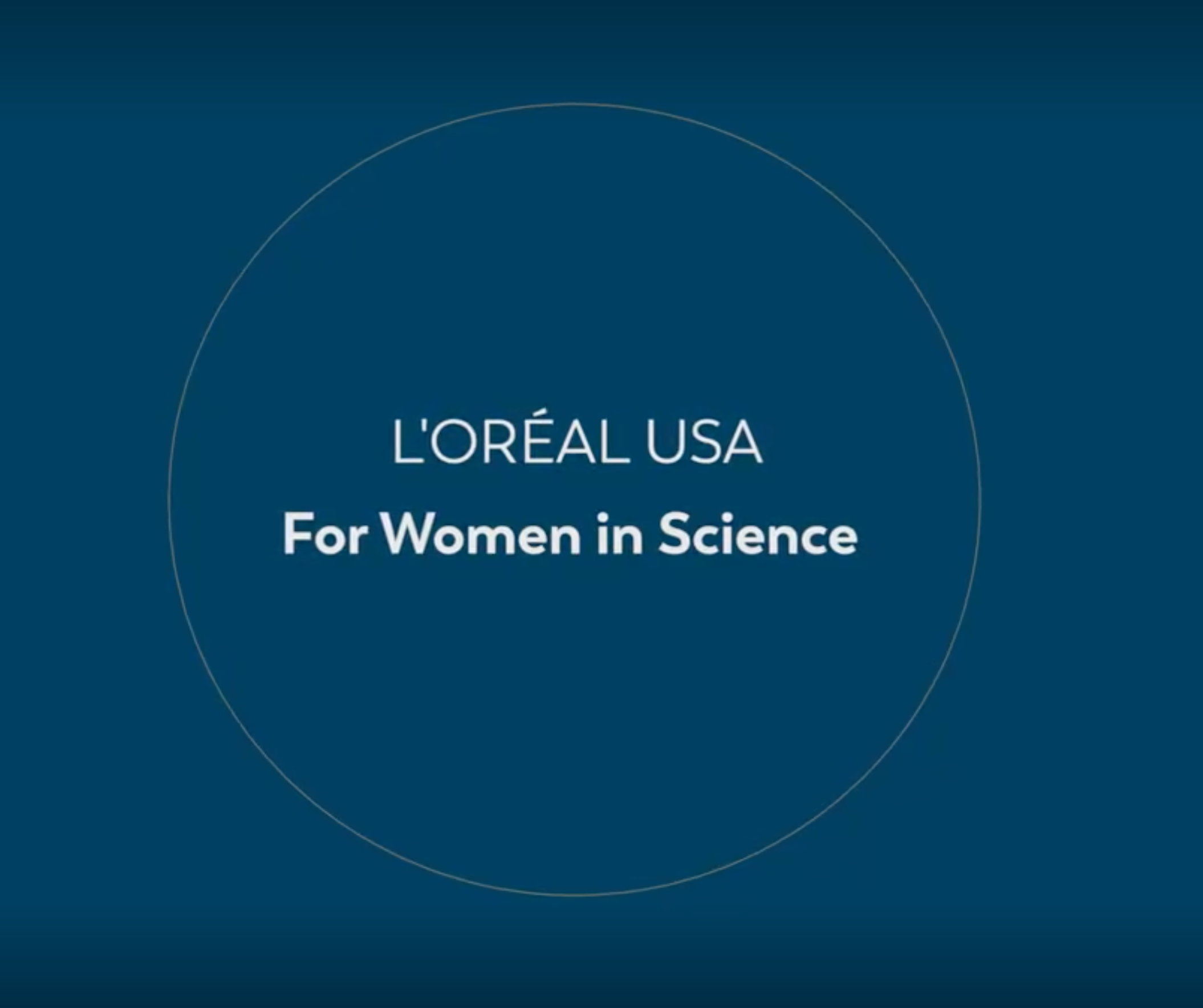 The words "L'Oreal USA For Women in Science" written in white against a dark blue background
