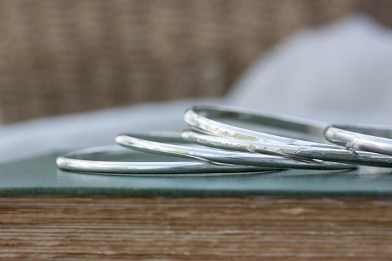 silver stacking bangles with textured surface