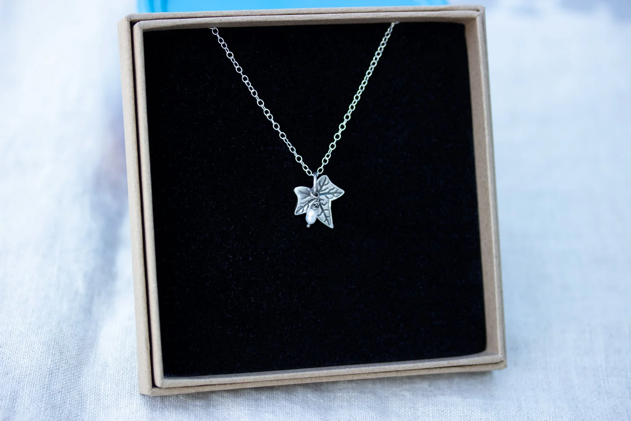 a recycled silver ivy leaf pendant in eco-friendly kraft brown gift box, sustainable silver jewellery from the little red hen