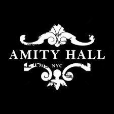 Logo for Amity Hall in NYC with decorative white design and text on a black background.