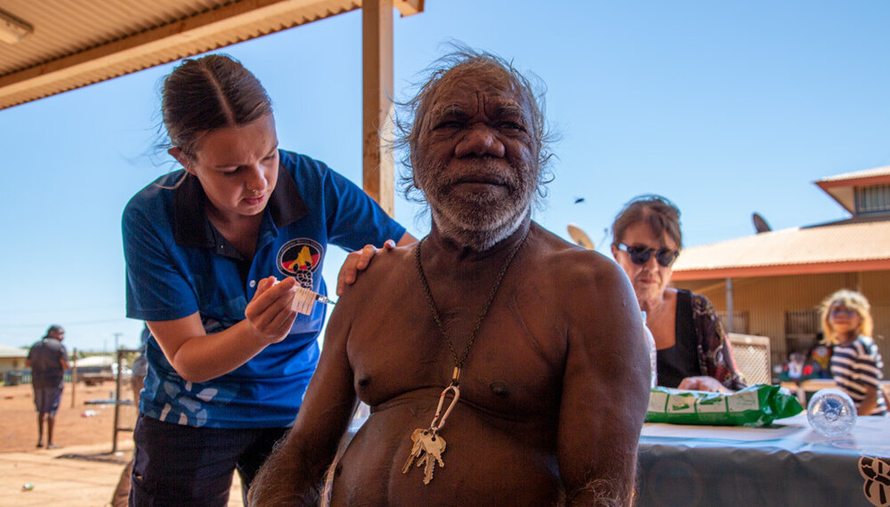 A man receives his first vaccination at Balgo, Kimberley Region