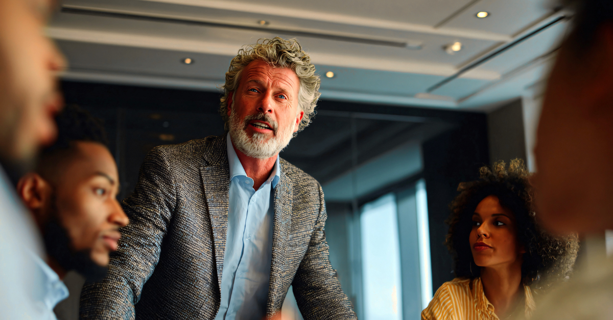 Executive giving a speech to some coworkers on an office