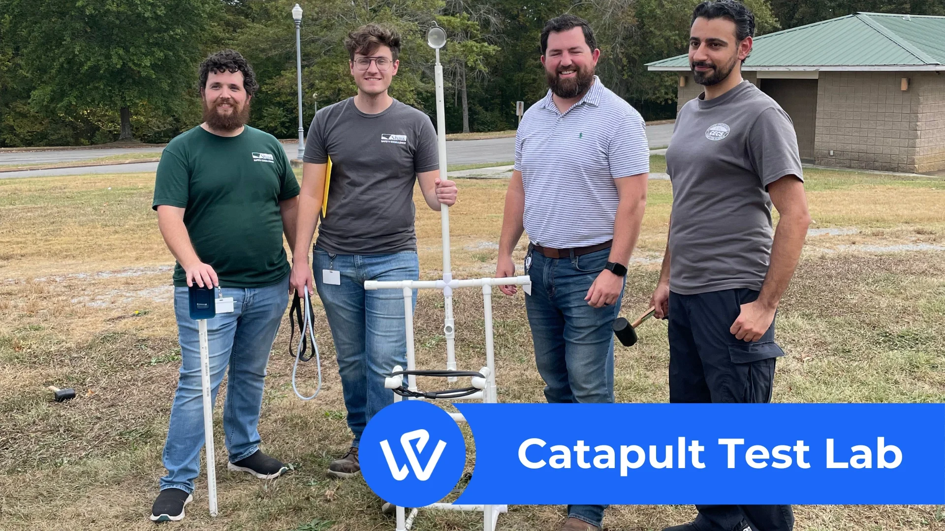 Four men posing with homemade PVC catapult at a WorkPlay Solutions Teambuilding event