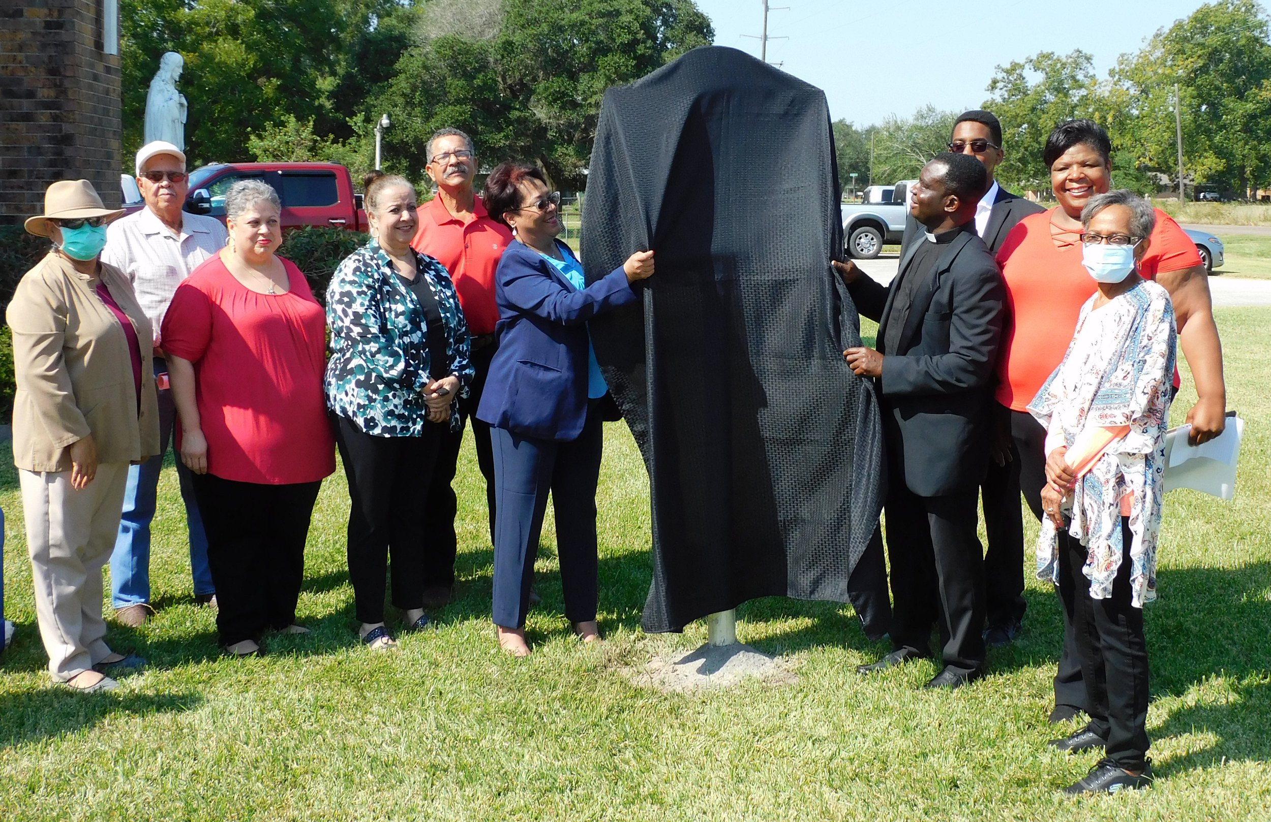  The unveiling with Rev. Mbamu, Elizabeth Harrison, Robynn Miller, Marcie Arceneaux and other parish council members. 