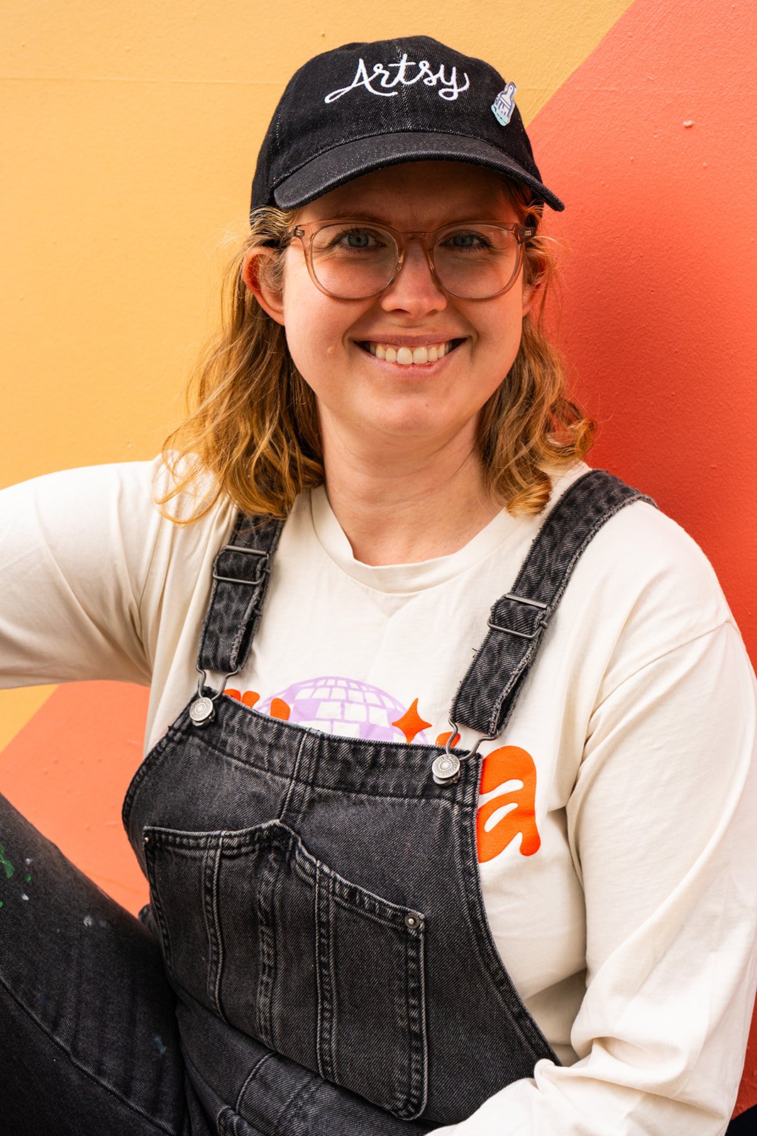Portrait of Elaine in front of a colorful wall