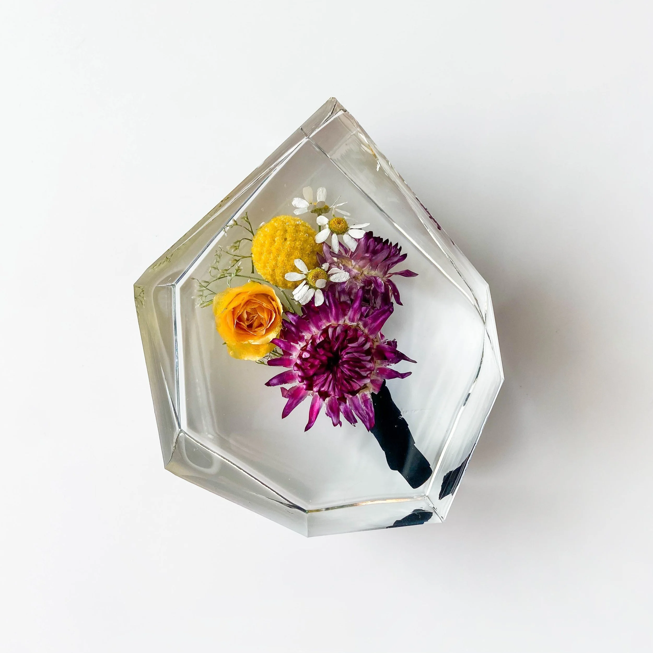 Shown is our small gem resin block with a buttonhole from my wedding day included inside. The buttonhole was worn by my husband and includes straw flowers, camomile and billy buttons