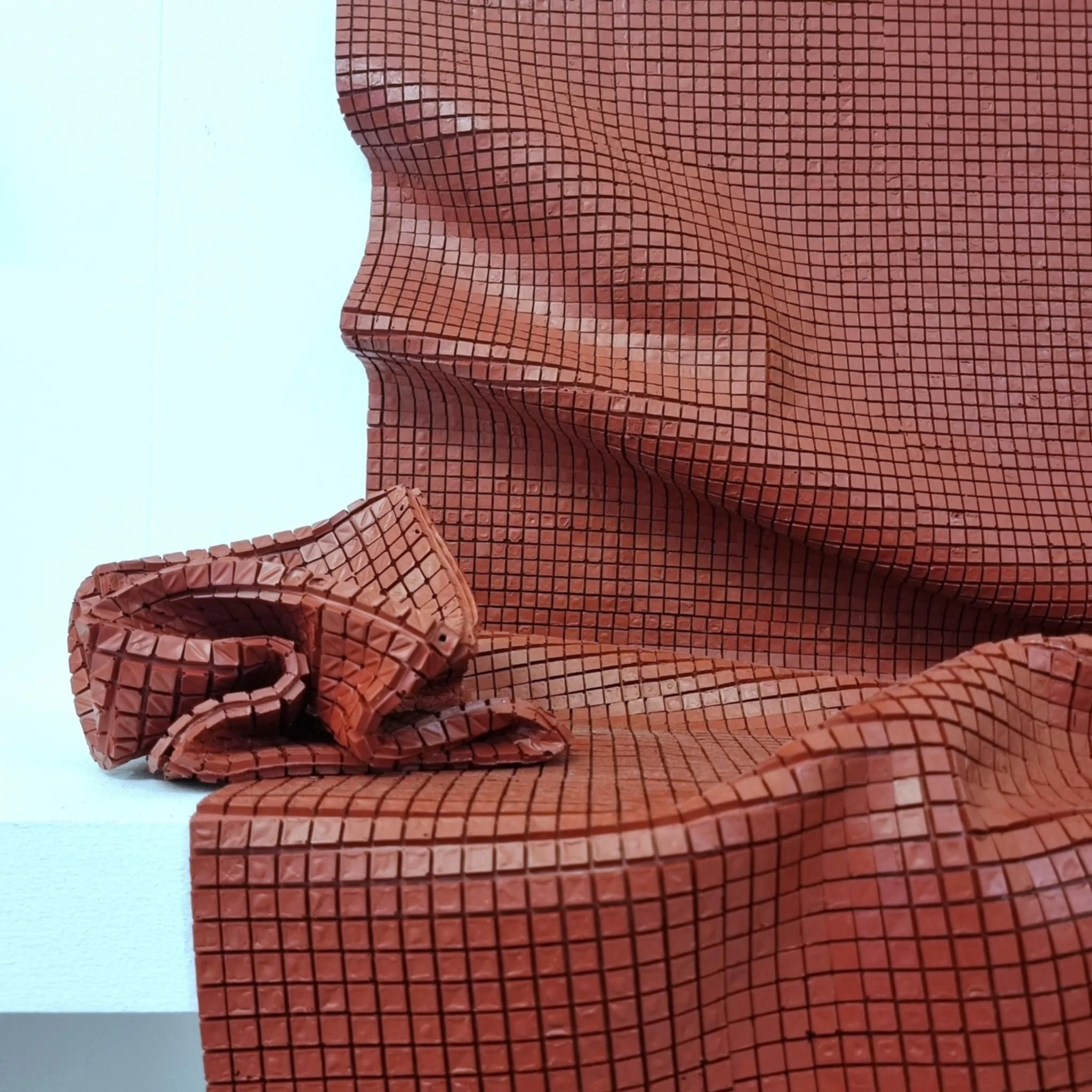 Red gridded sculpture made entirely from dried acrylic paint.