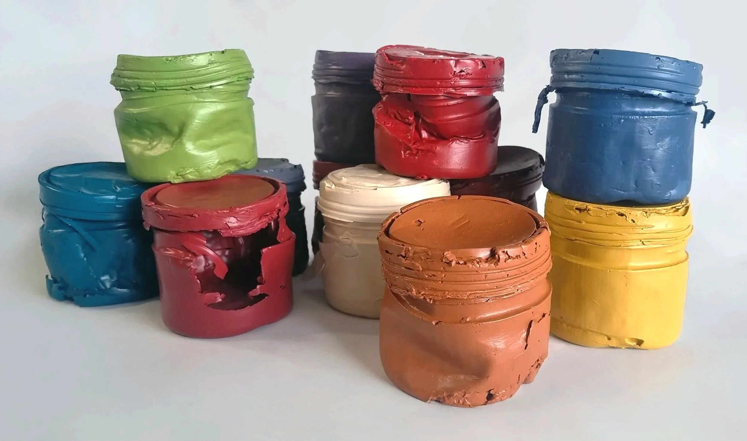 Small containers made entirely from paint in different colours