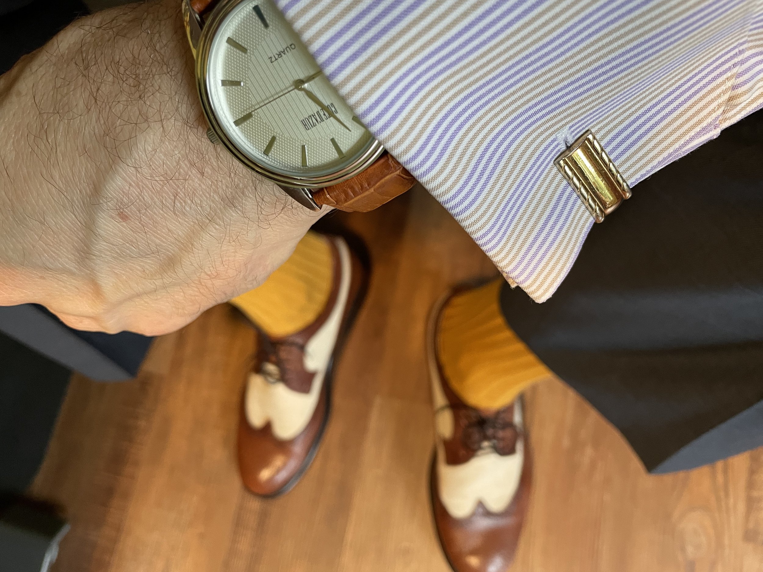 The accessory coordination downshot. The leathers are coordinated brown. Bold socks and spectators add the jazz.