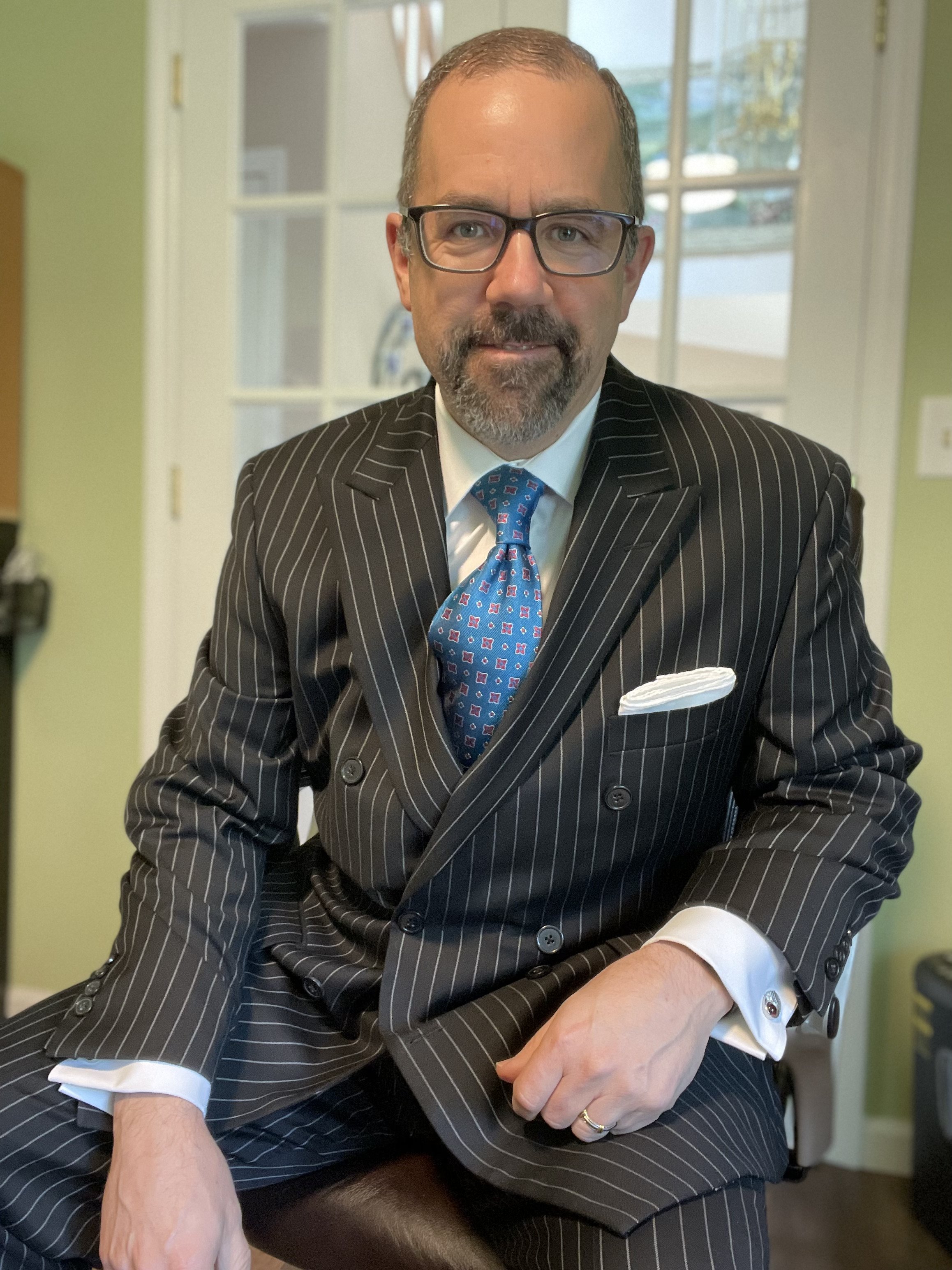 A double breasted chalk stripe suit is the epitome of power business. A white shirt and simpler accessories are ideal here.