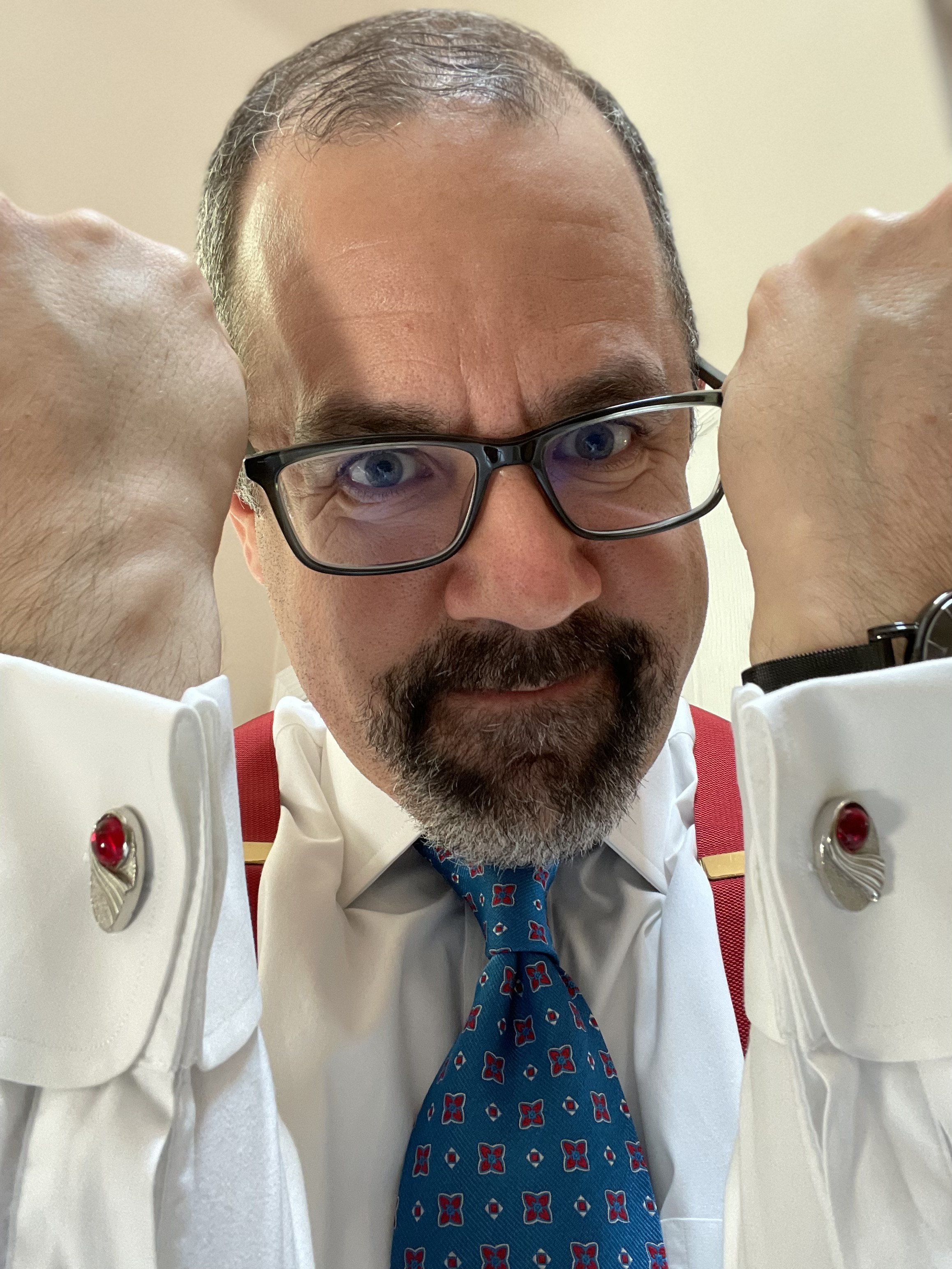 The tie's base, or primary, color is the bright teal. The secondary color is red, and I use the accessories to accentuate and bring out the red more.