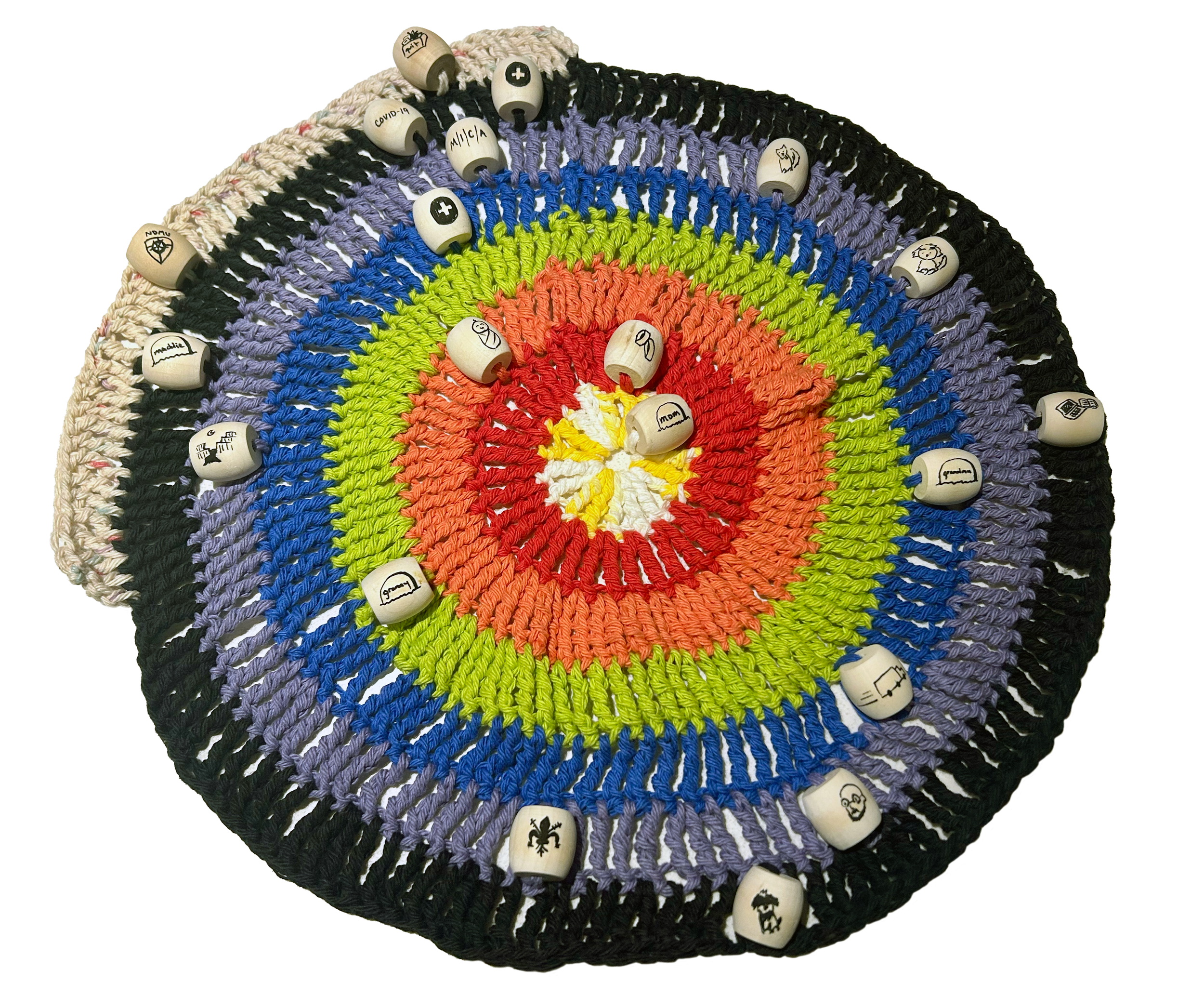 My Development, 2026. Crocheted acrylic yarn, wooden beads, and Sharpie. 17 x 17 inches. 