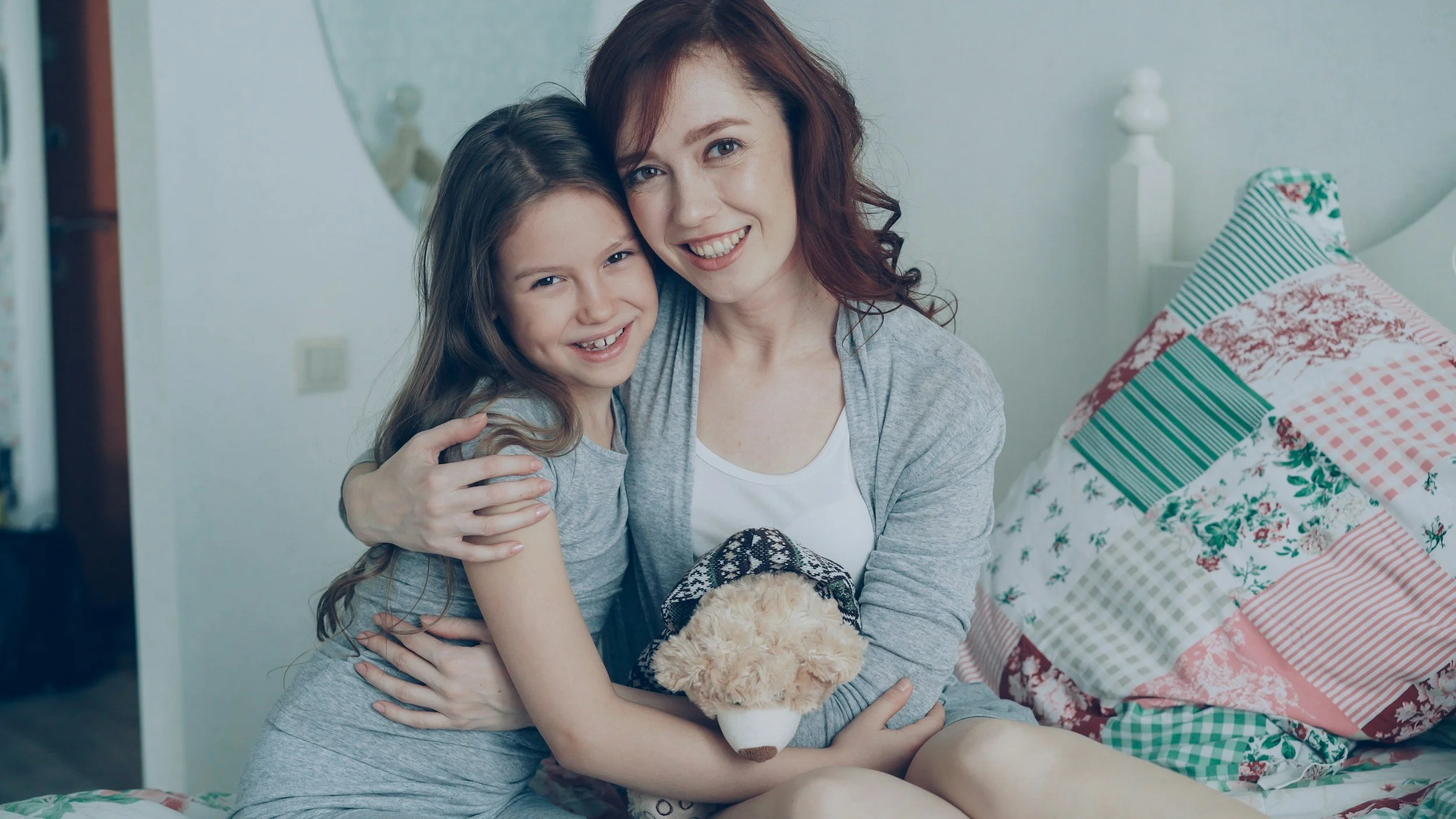 nanny hugging a smiling child
