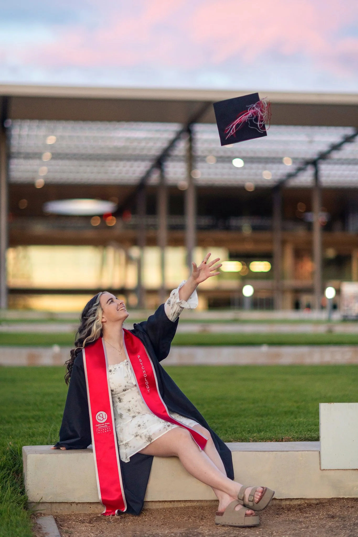 Grad cap and gown portrait throwing cap