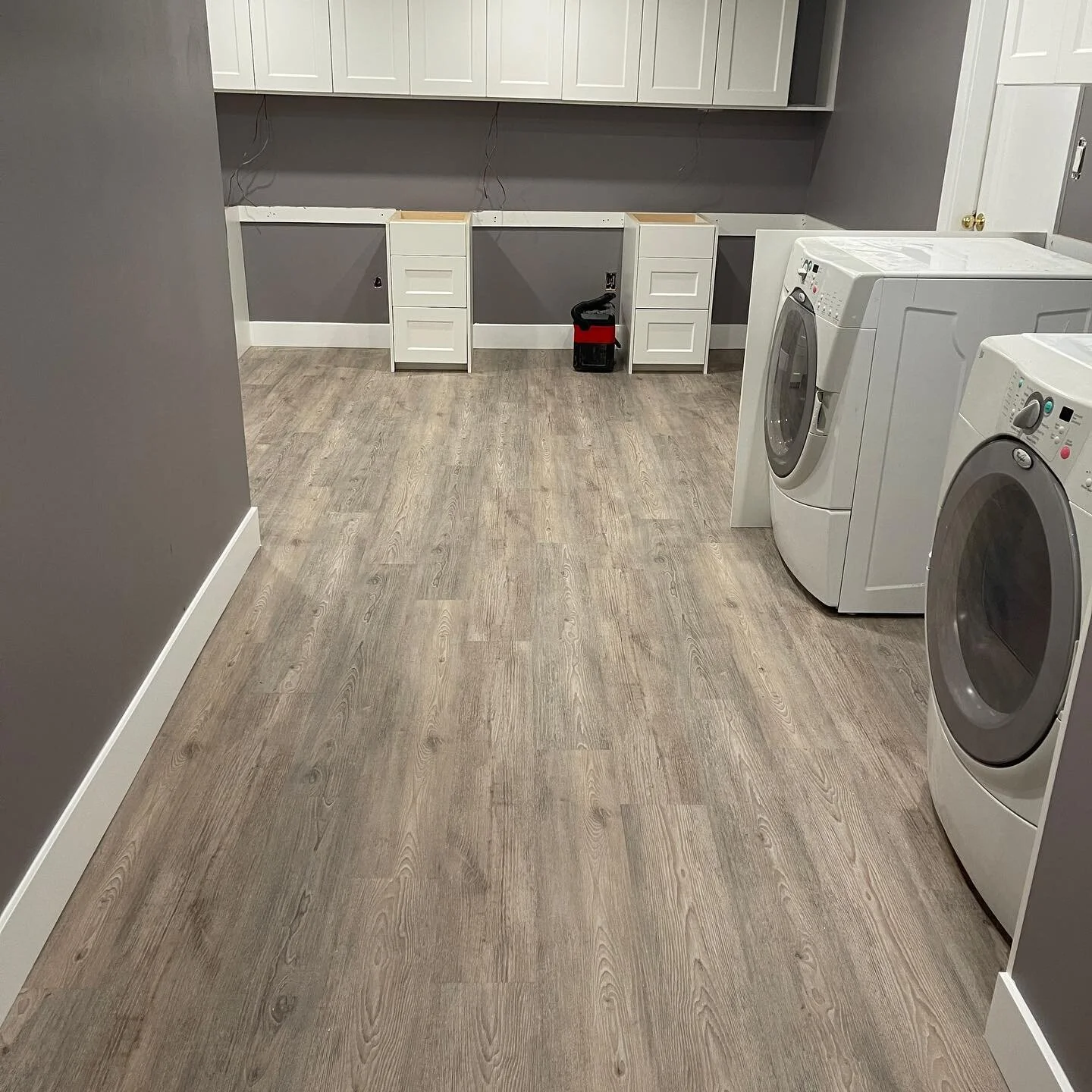This basement office / laundry is coming along nicely, waiting for quartz countertops and a couple small things to wrap it up @movaitriple colour Seagrass #luxuryvinylplank @euroritecabinets