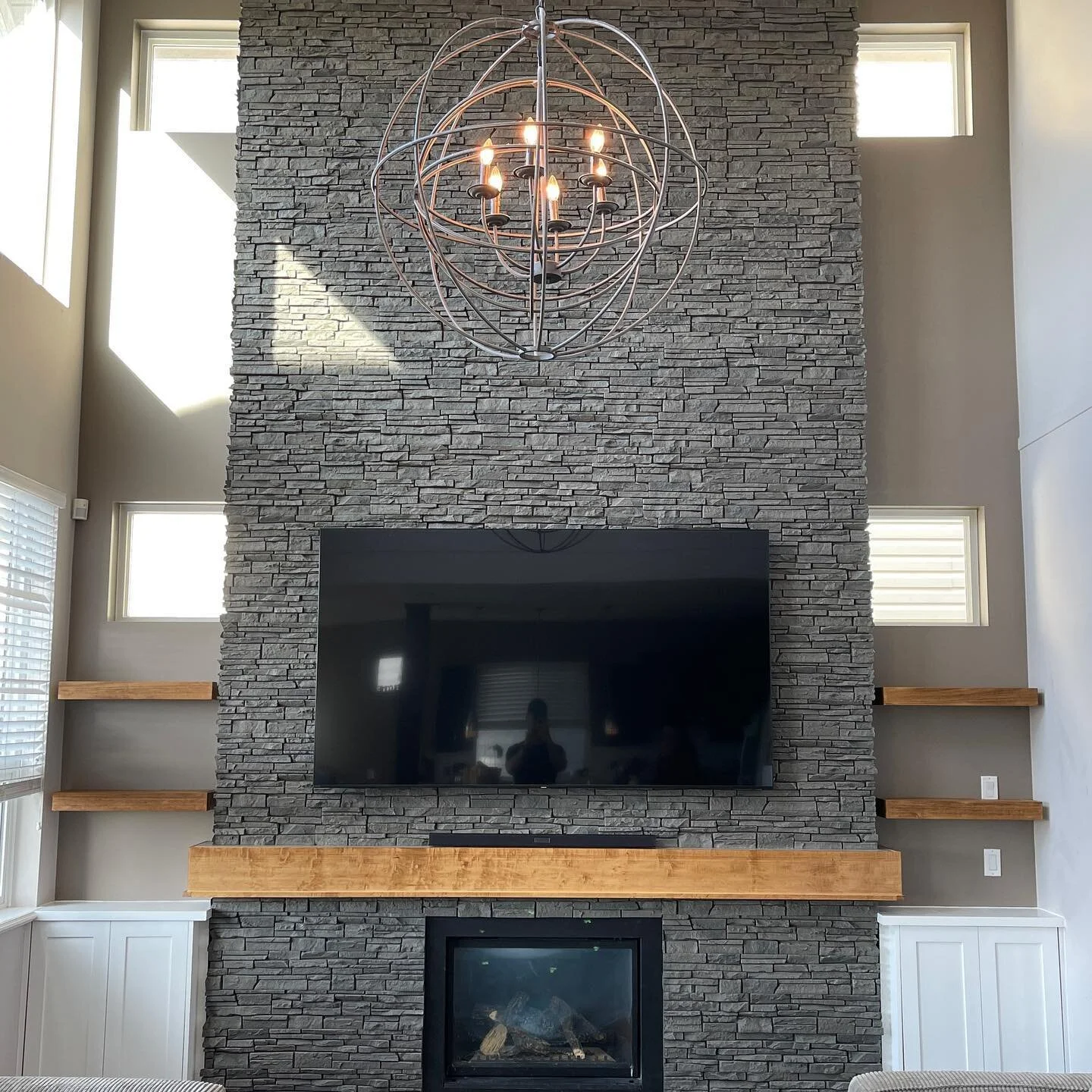 This rock wall and cabinets with floating shelves turned out awesome