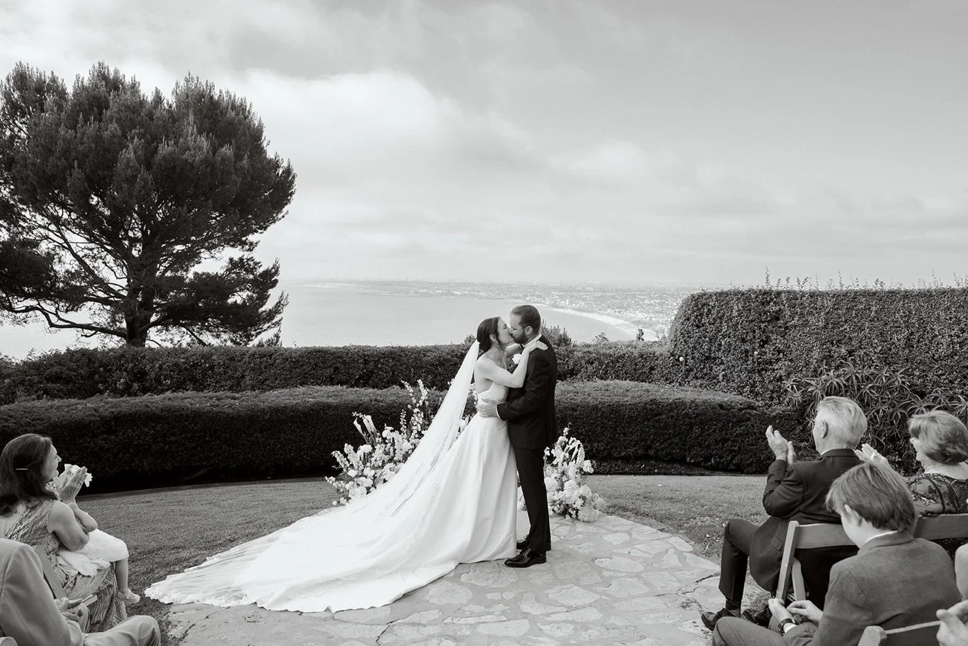 a black and white photo of a wedding ceremony at la venta inn in palos verdes estates california
