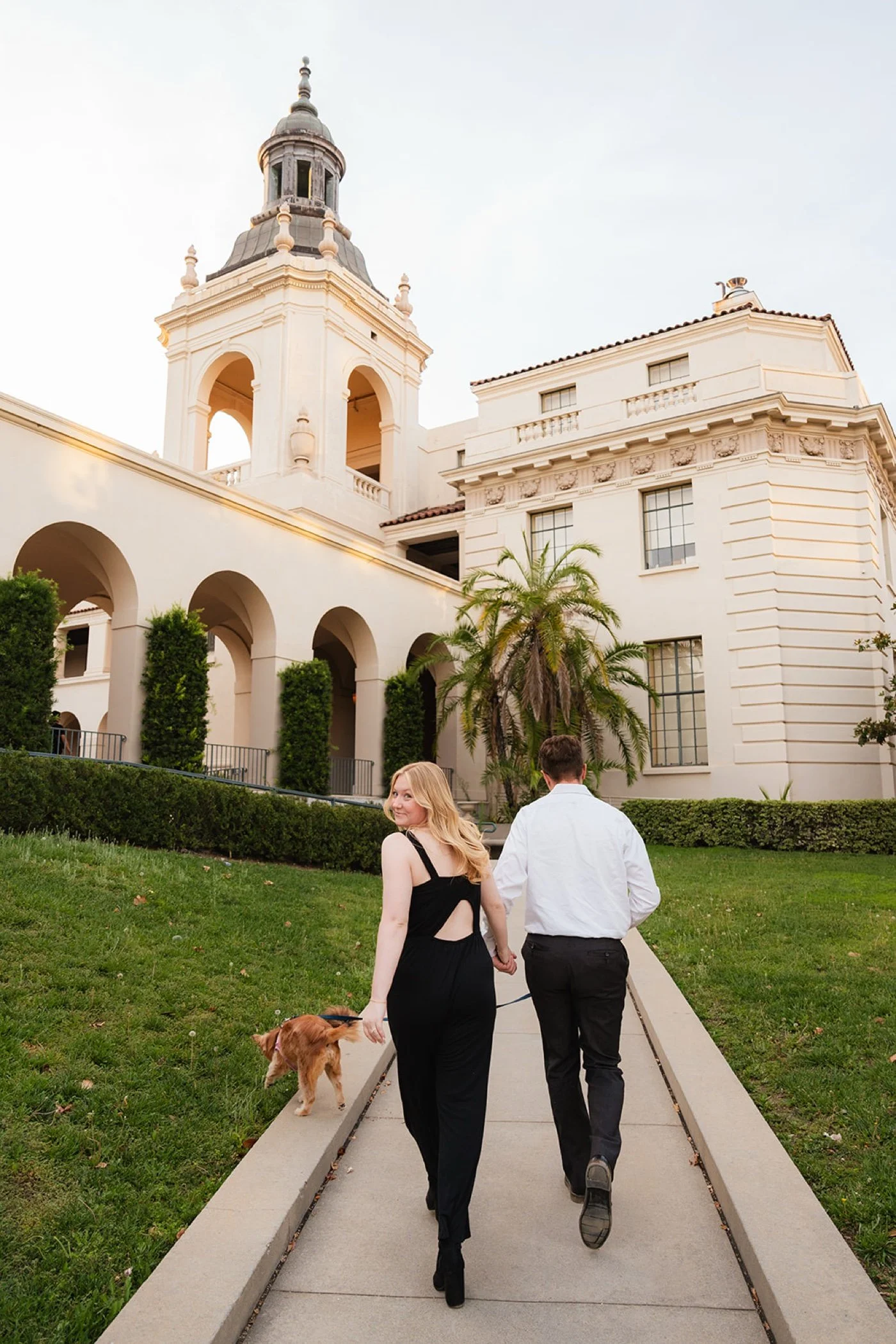 man and woman taking engagement photos at pasadena city hall