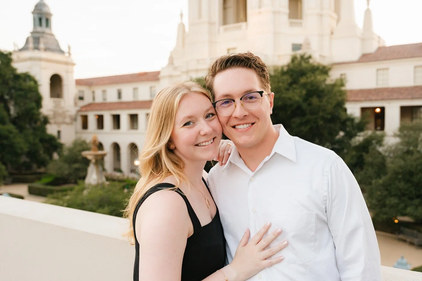 man and woman taking engagement photos at pasadena city hall