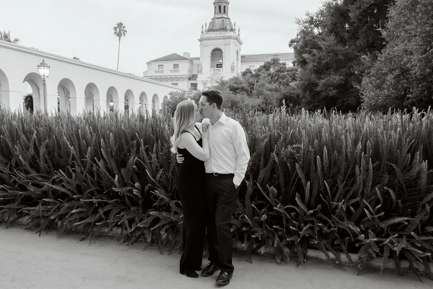 man and woman taking engagement photos at pasadena city hall
