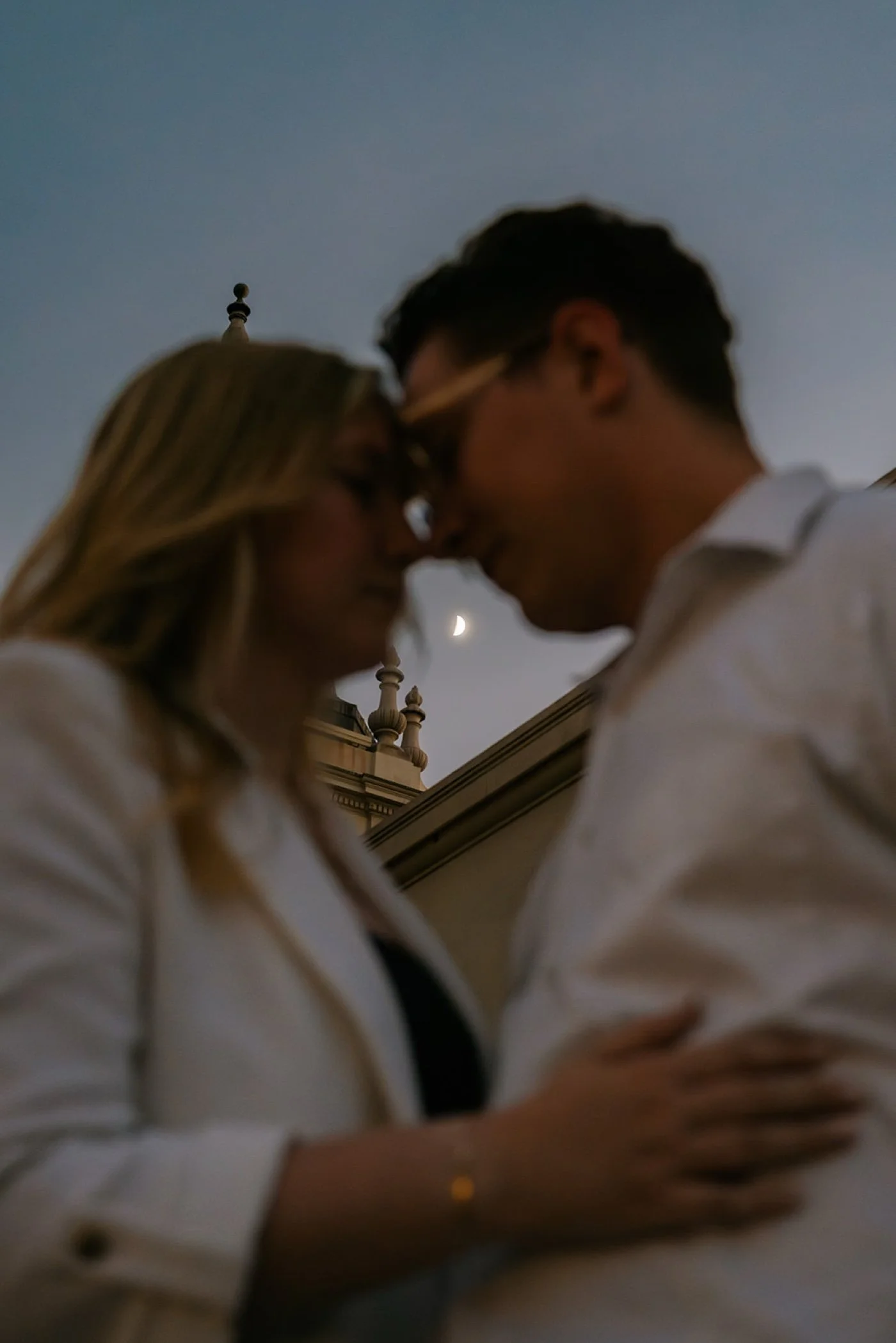 man and woman taking engagement photos at pasadena city hall