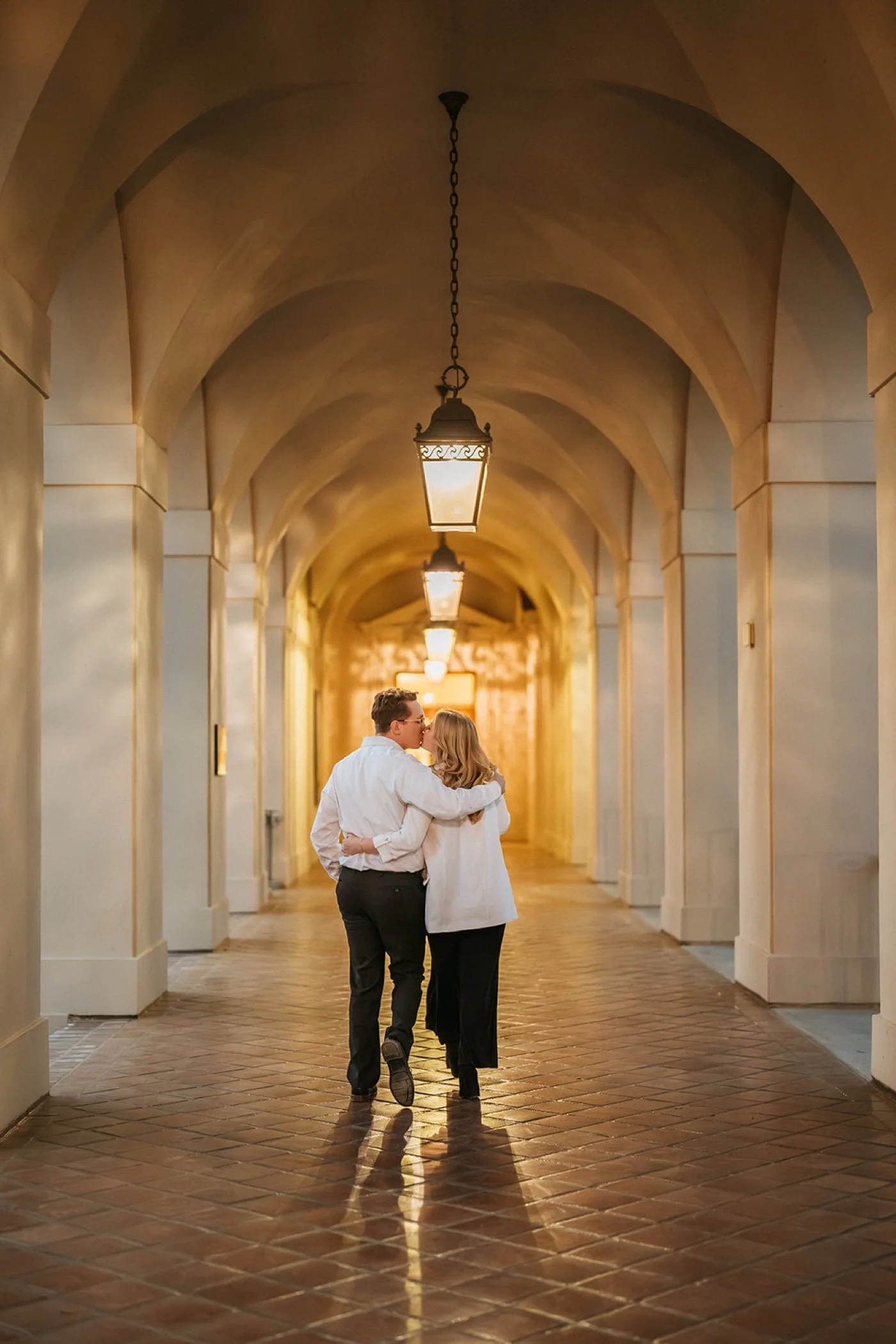 man and woman taking engagement photos at pasadena city hall