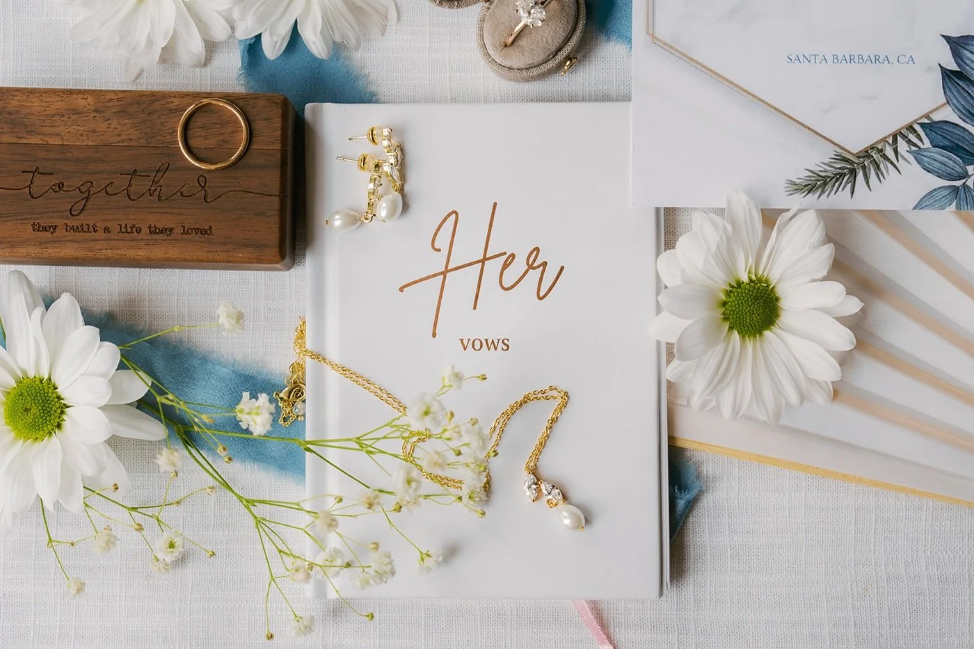 a blue and white wedding details flat lay