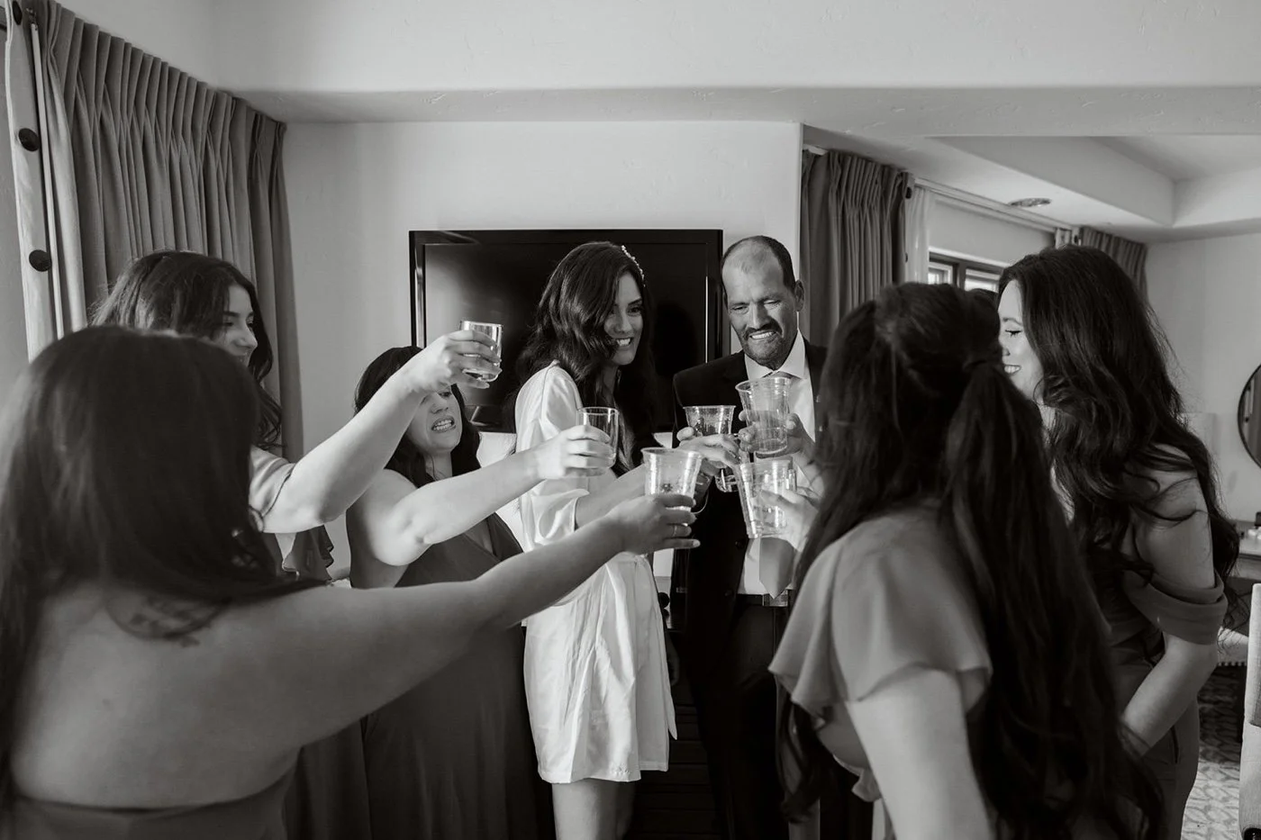 bride and her bridal party toasting on the morning of her wedding