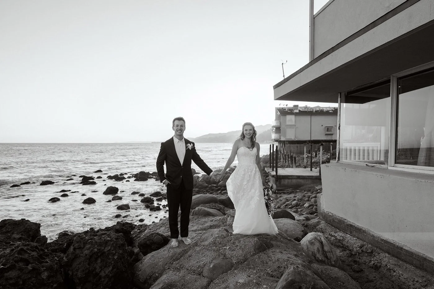 bride and groom taking portraits at sunset at their duke's malibu wedding