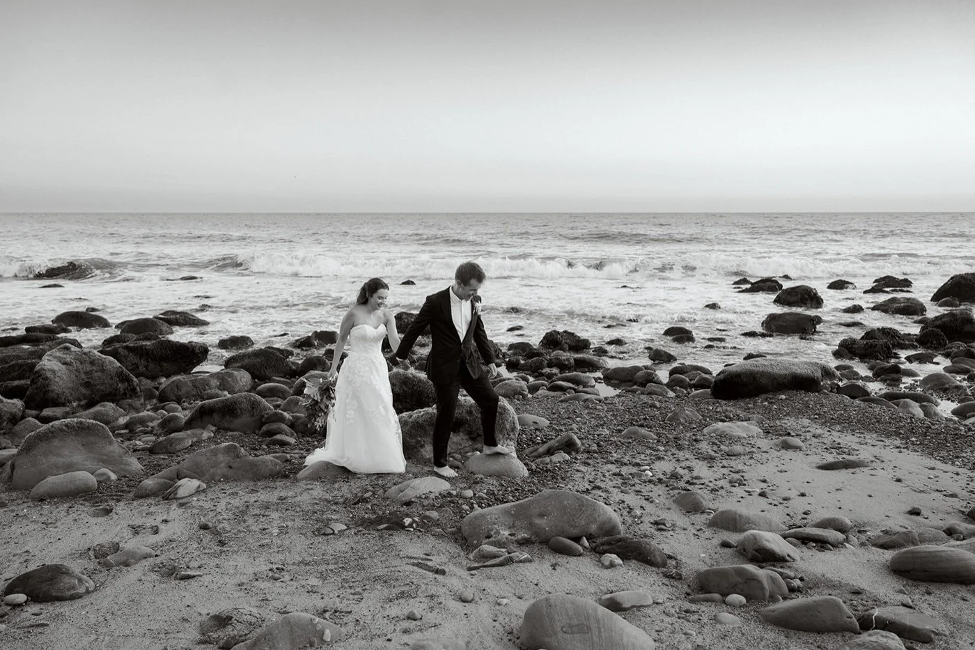 bride and groom taking portraits at sunset at their duke's malibu wedding
