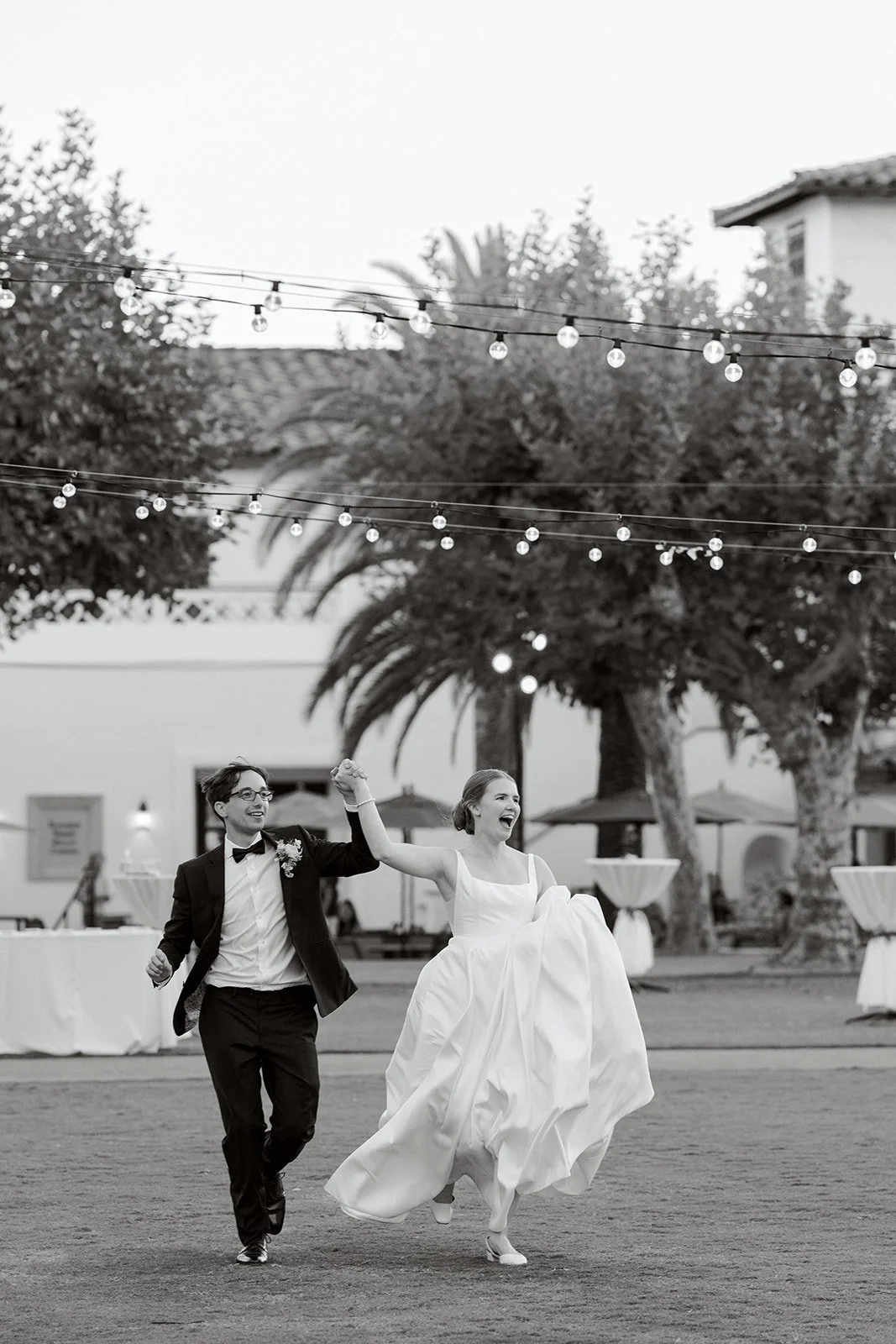 a bride and groom running to their wedding reception in los angeles california