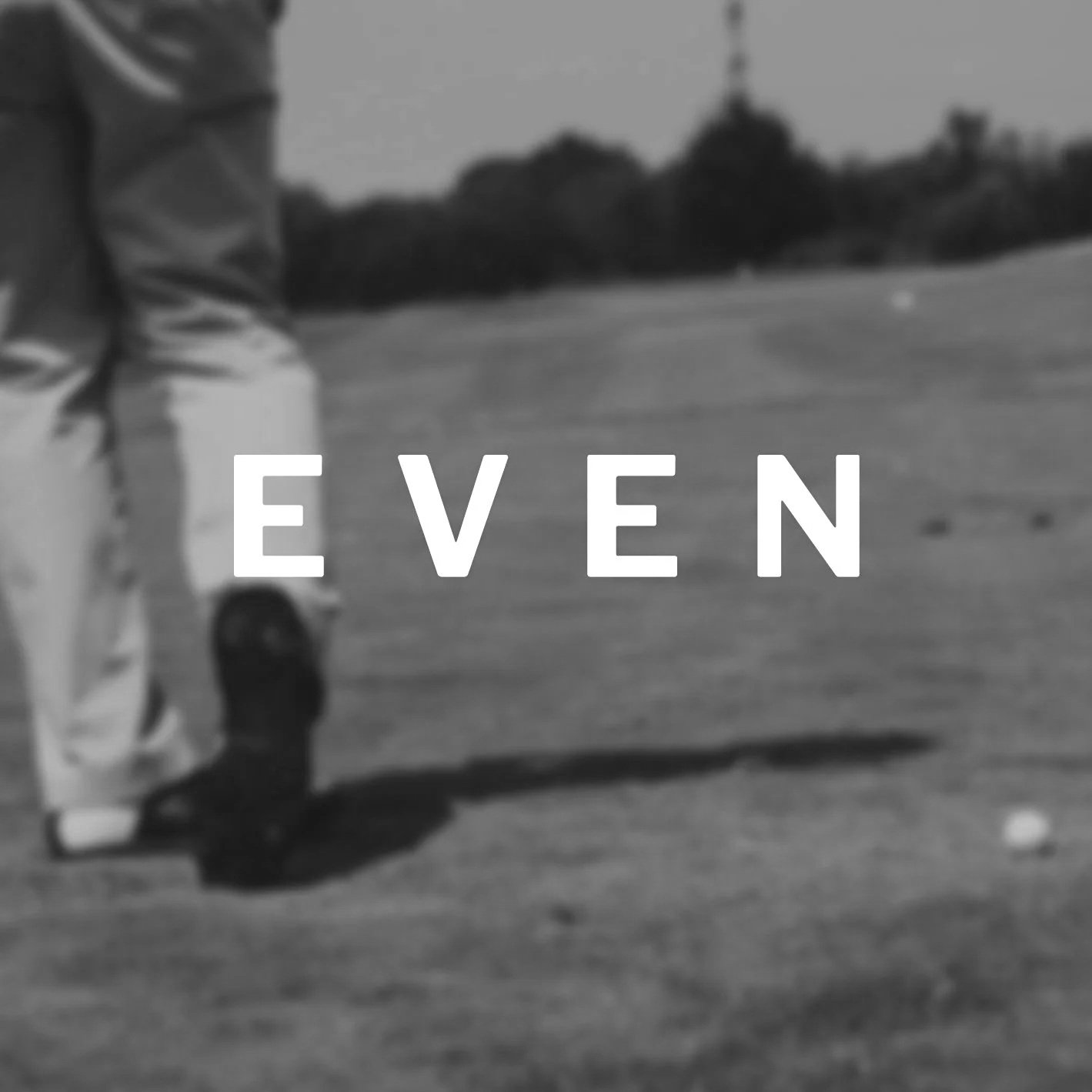 Close-up of a person standing on a sidewalk, with the word "EVEN" overlaid on the image in large white letters.