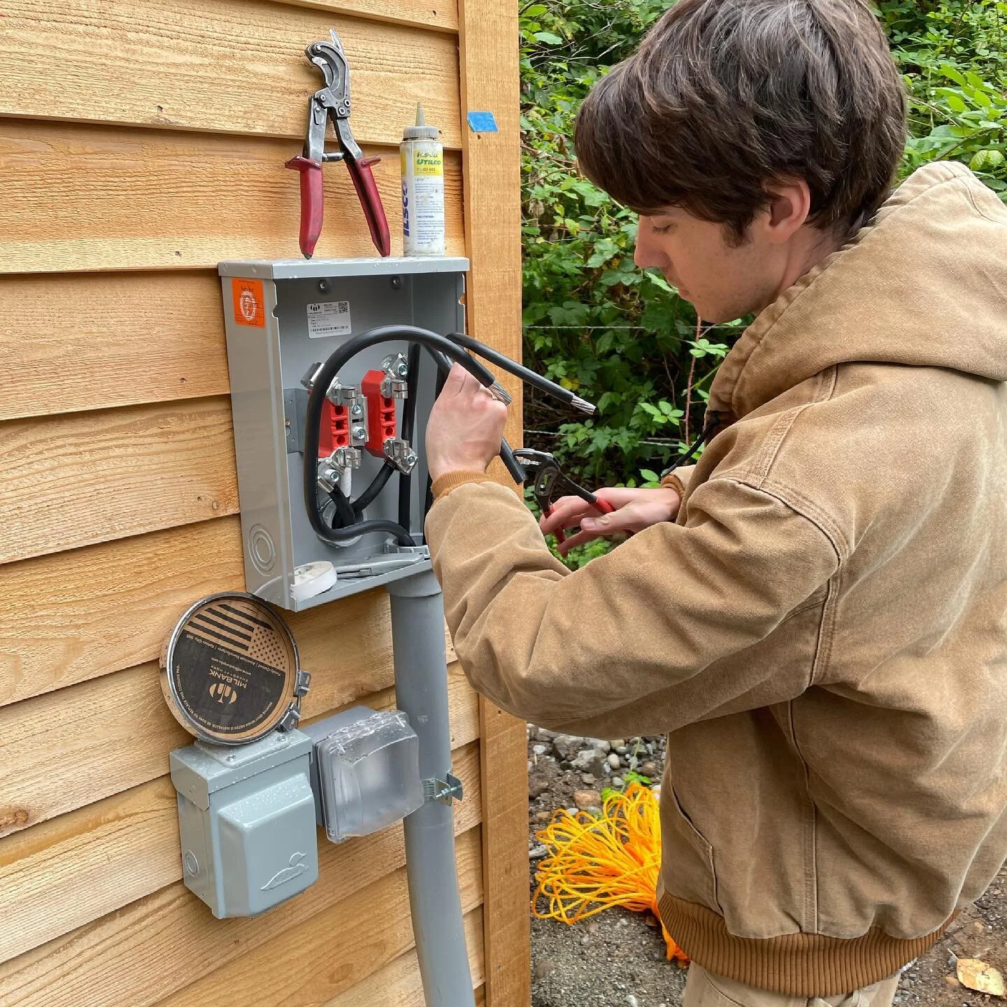 Evan hooks up the meter base for the new custom home were wiring.