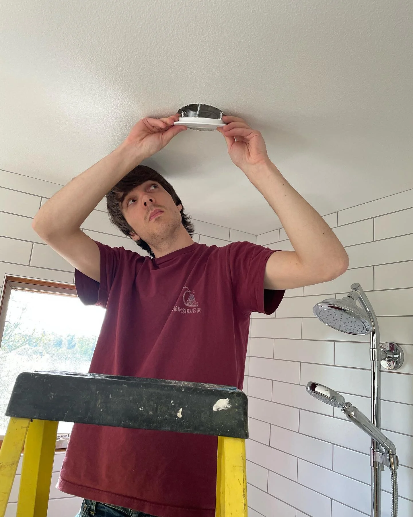 Trevor installing recessed cans.