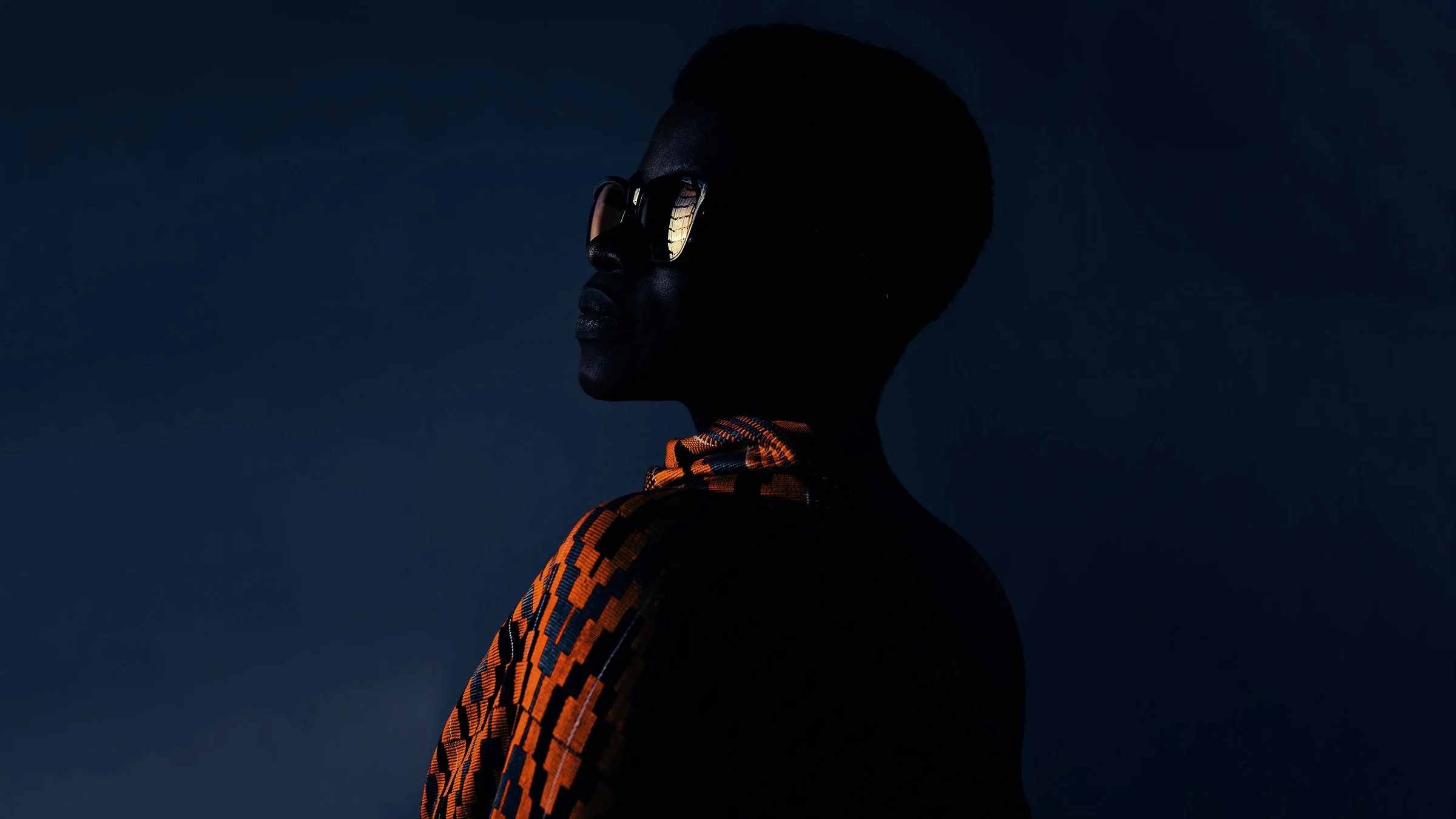 Young Ghanaian woman wearing sunglasses — documentary portrait by Black Shutter Productions