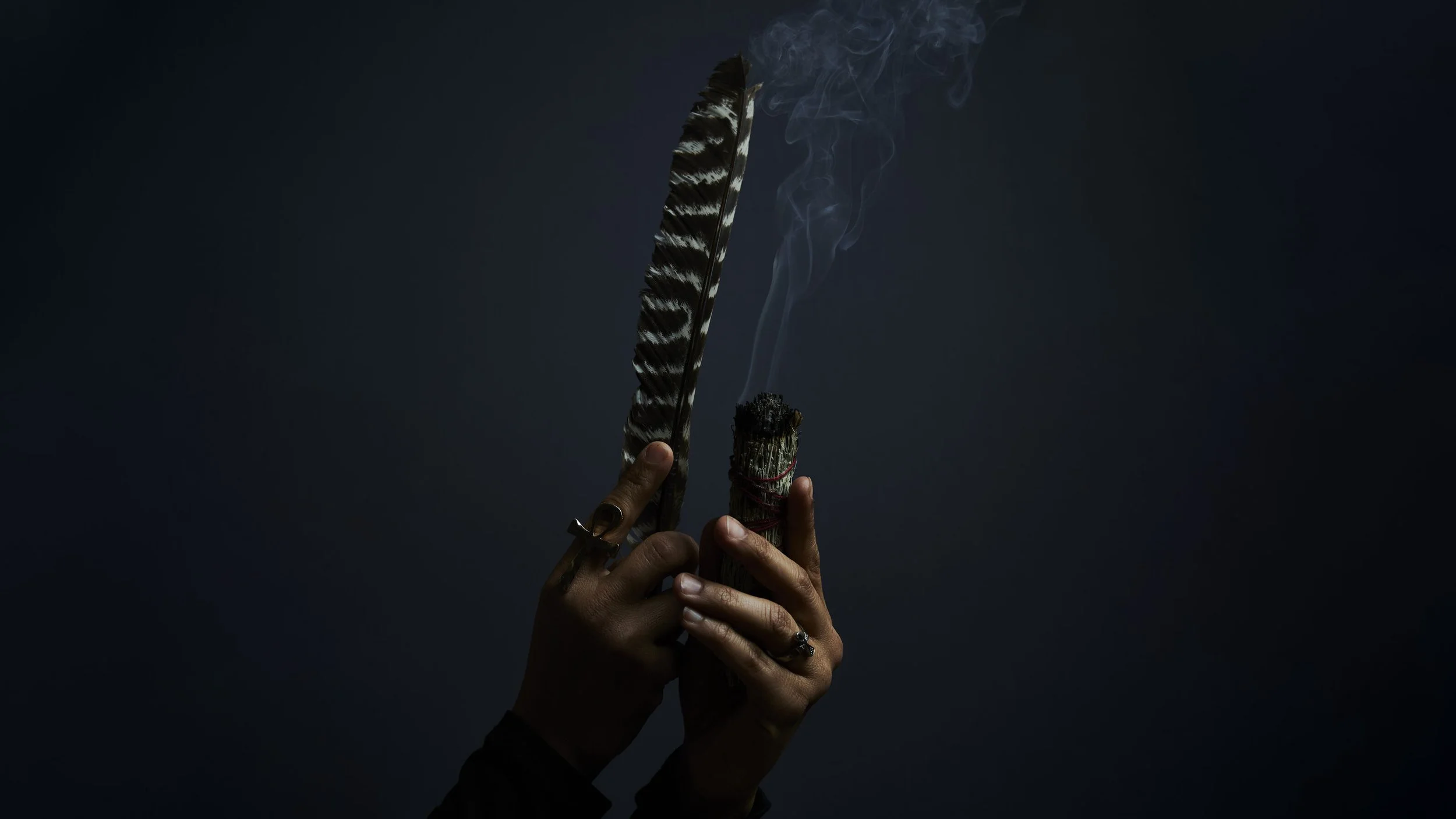 Afro-Latina hands holding feather and sage — documentary portrait by Black Shutter Productions