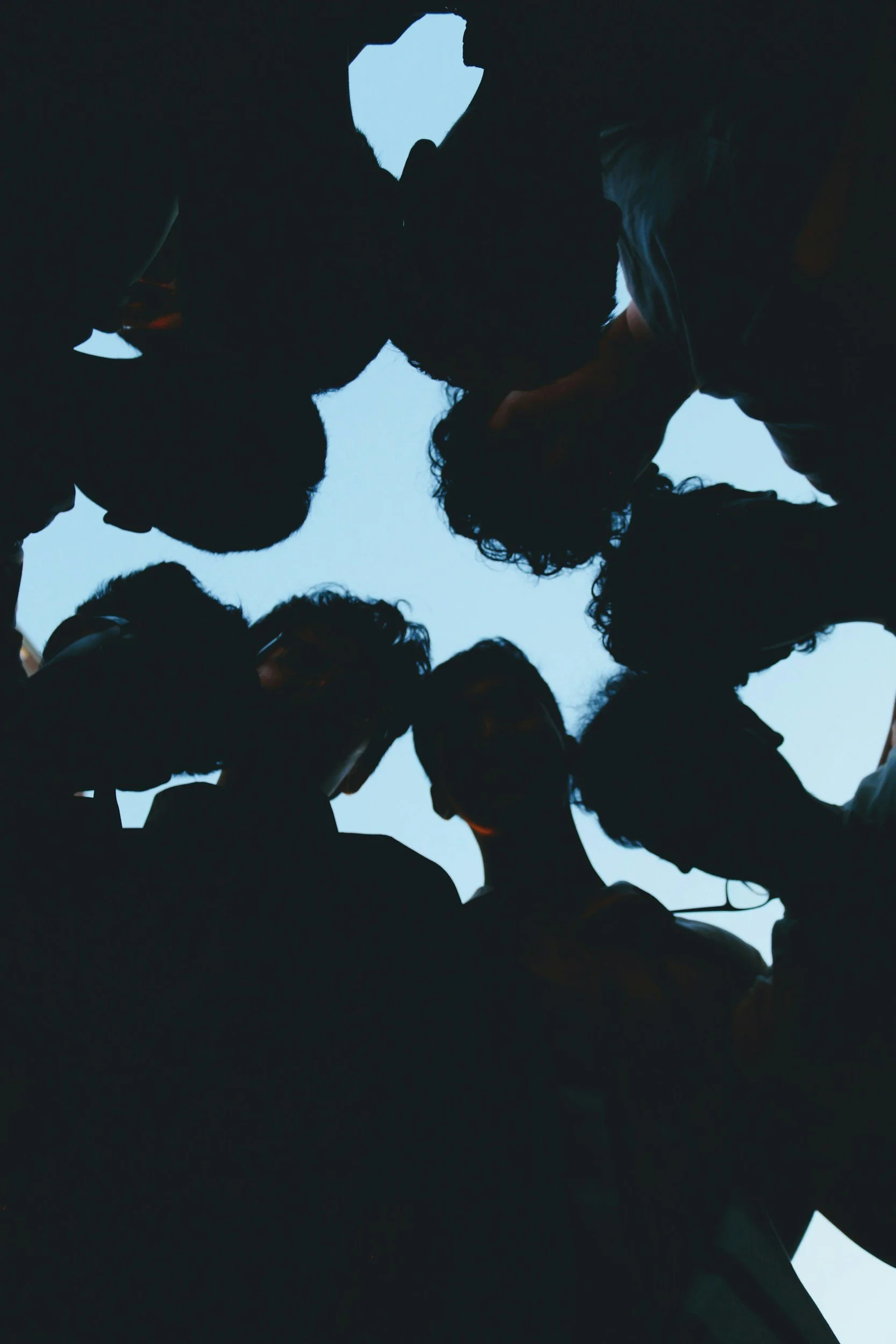 sillouhettes of humans in a huddle