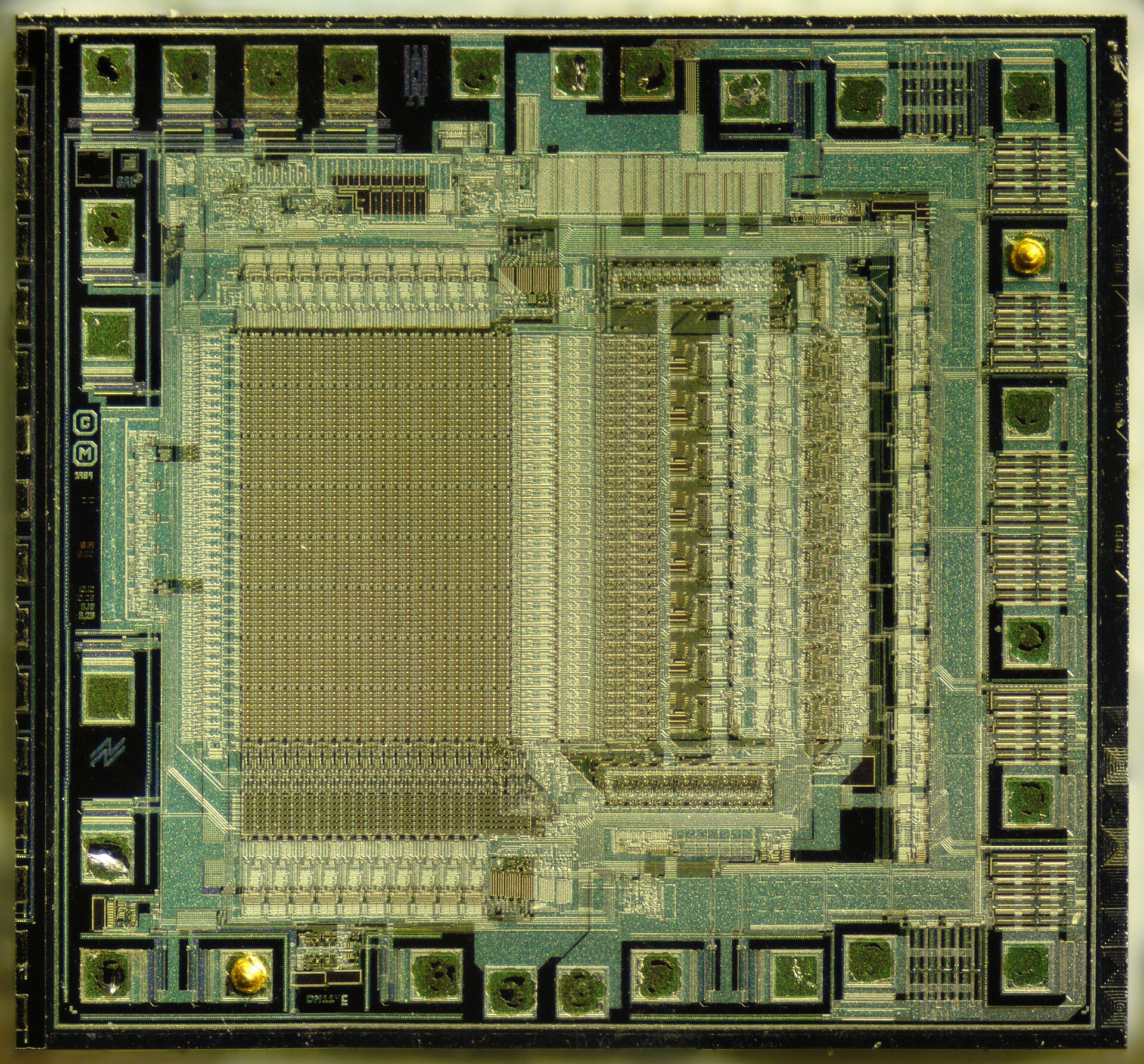 Close-up of a microchip with visible circuit patterns and internal structures.