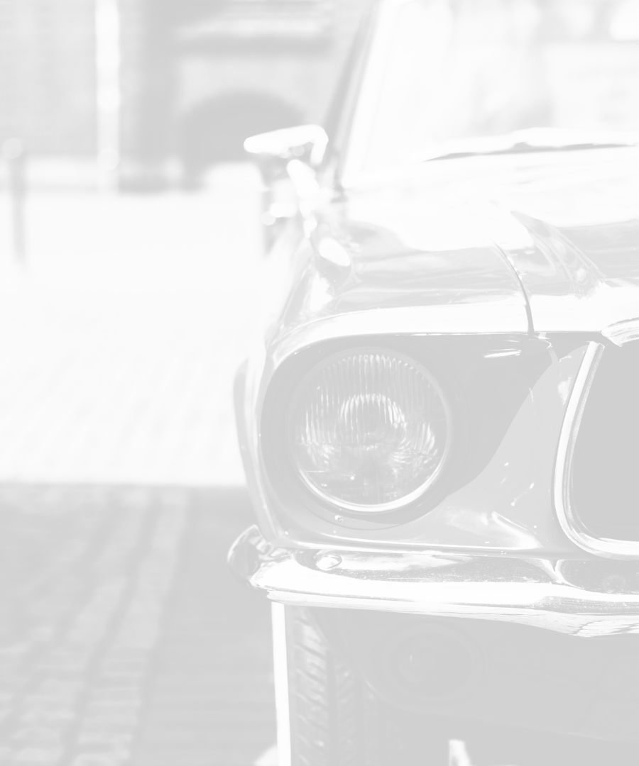 Close up a vehicle displaying the headlights and grill