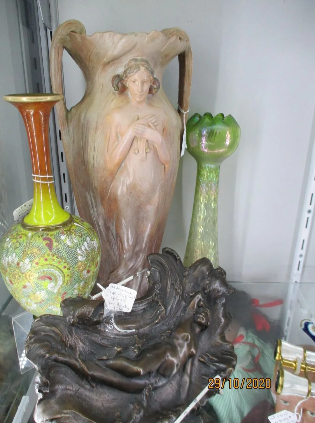 A silhouette of a woman is displayed on both an Austrian ceramic vase and a Swiss bronze. The Royal Doulton vase with a different colour way which is beautiful.