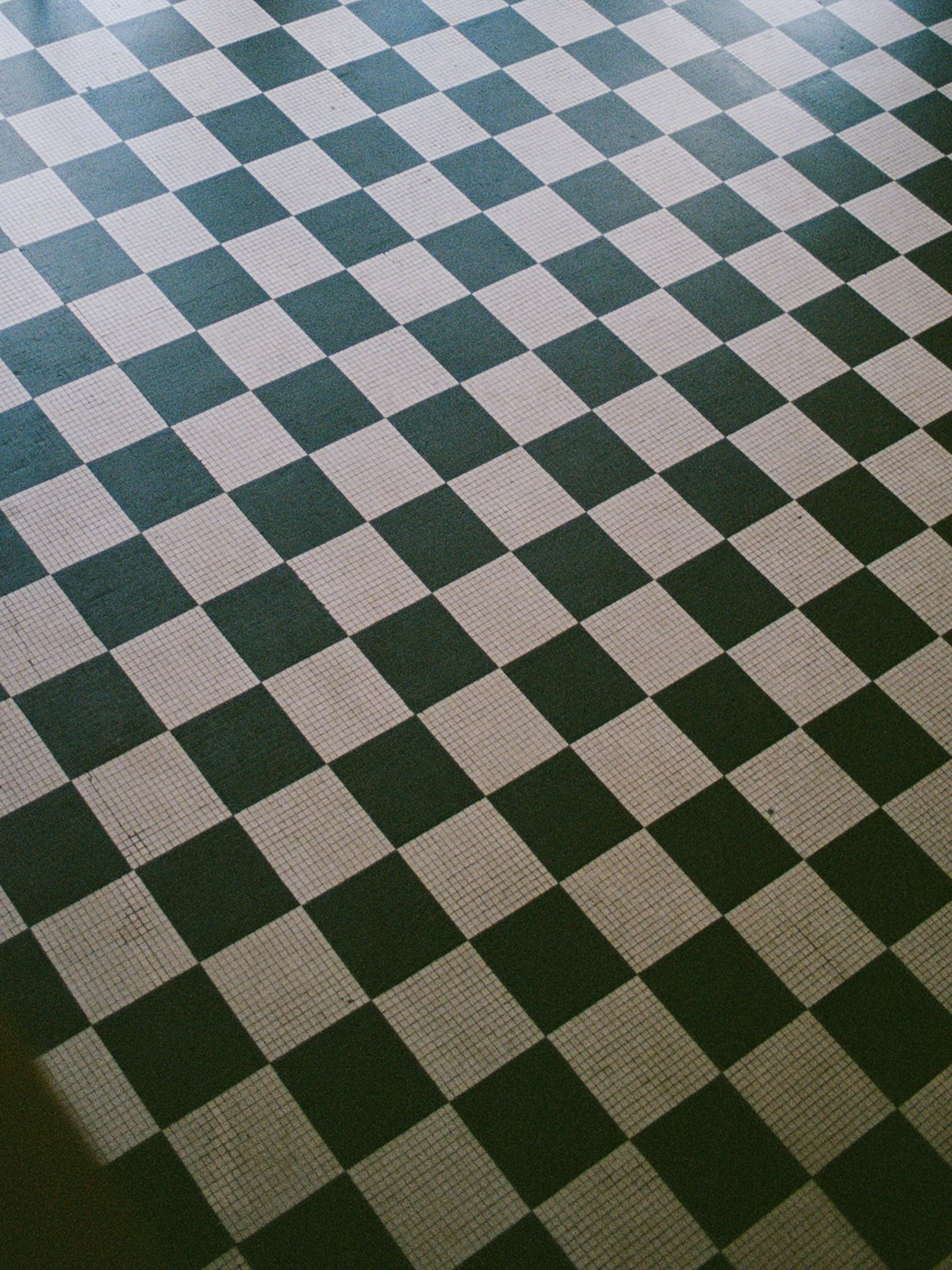 The iconic black-and-white checkered tile floor of Columbus Park Refectory — a graphic, timeless architectural detail that anchors the historic character of this beloved Chicago wedding venue