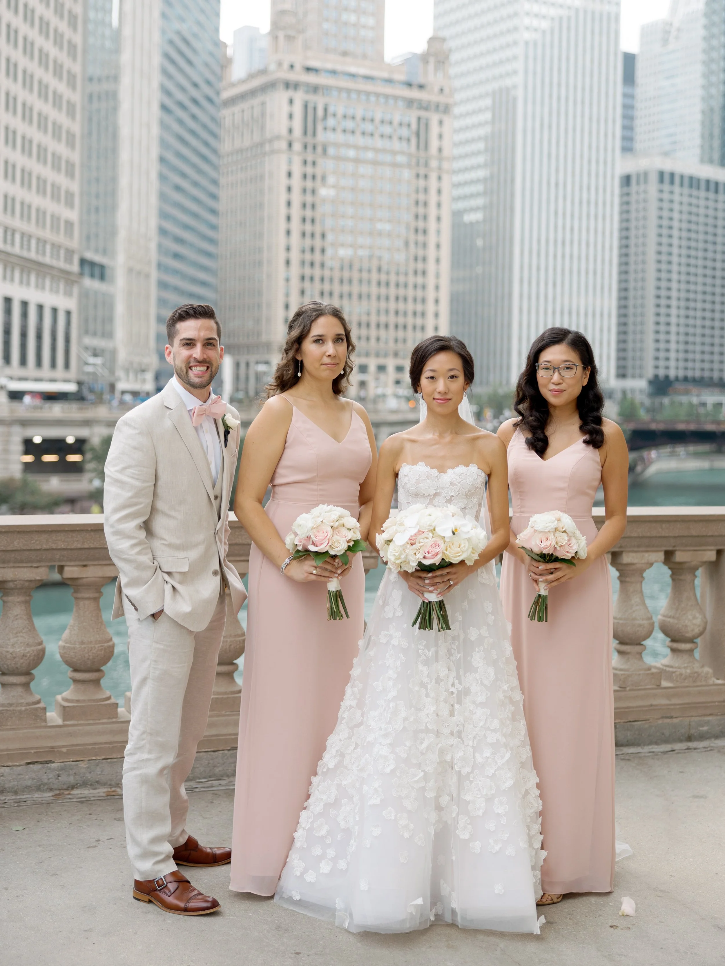 Film bridal party portrait with bridesmaids in blush and a groomsman on a bridge above the Chicago River
