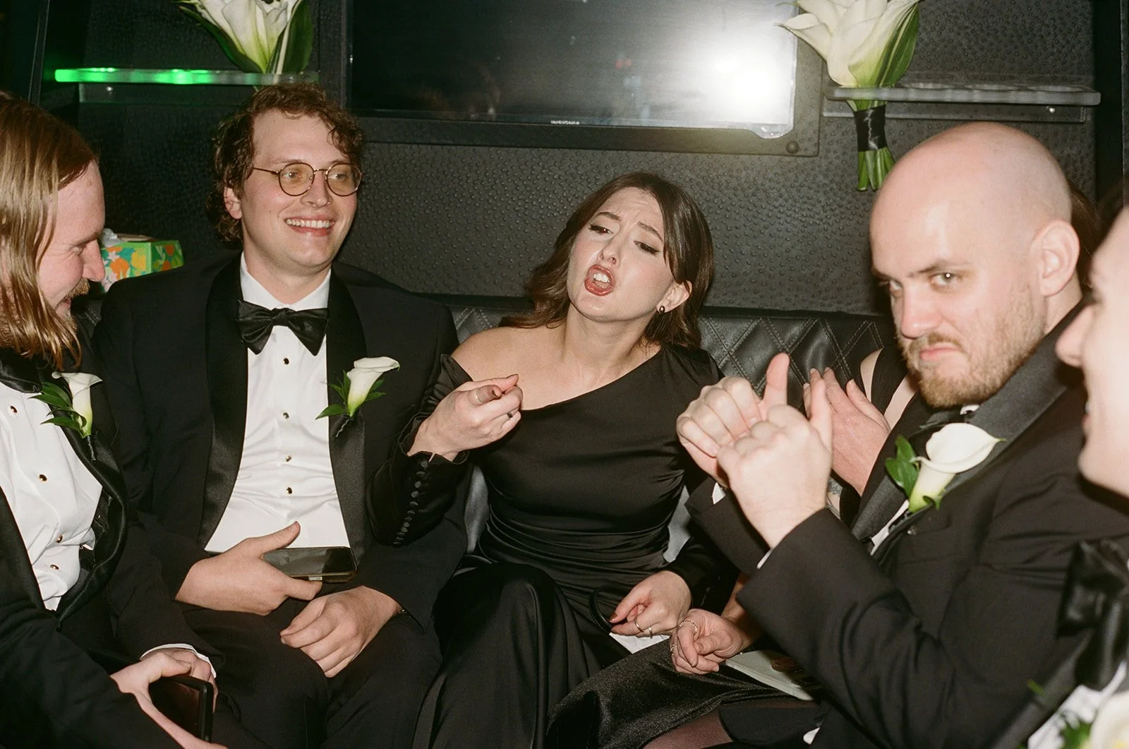 Wedding guests in formal black tie gathered on the grand staircase at Chicago Cultural Center. Shot on film by a Chicago wedding photographer.