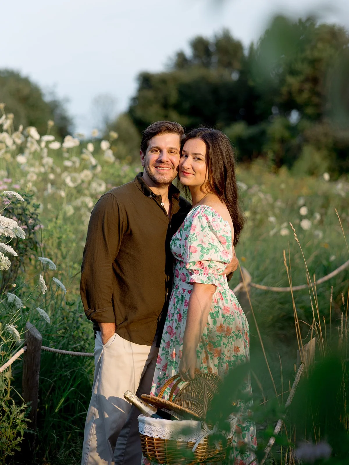 a couples portrait during their engagement session in a field