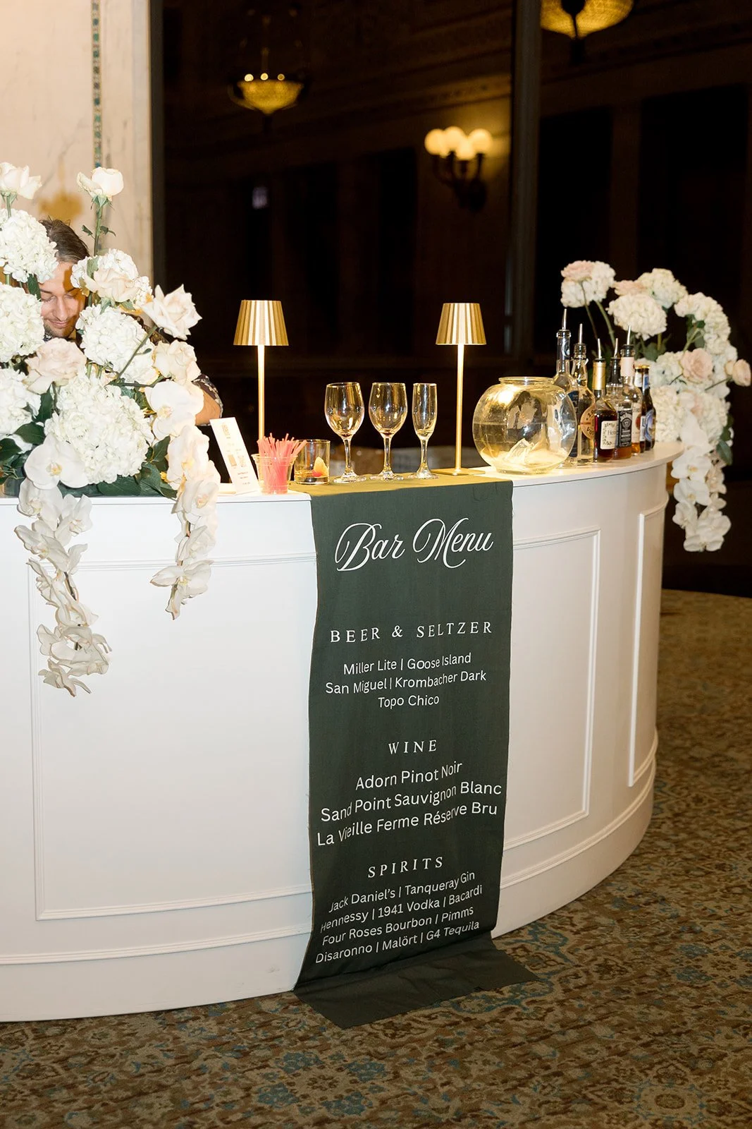 An elegant black chalkboard menu sign displaying cocktail options and open bar details at the reception. Shot on film by a Chicago wedding photographer.