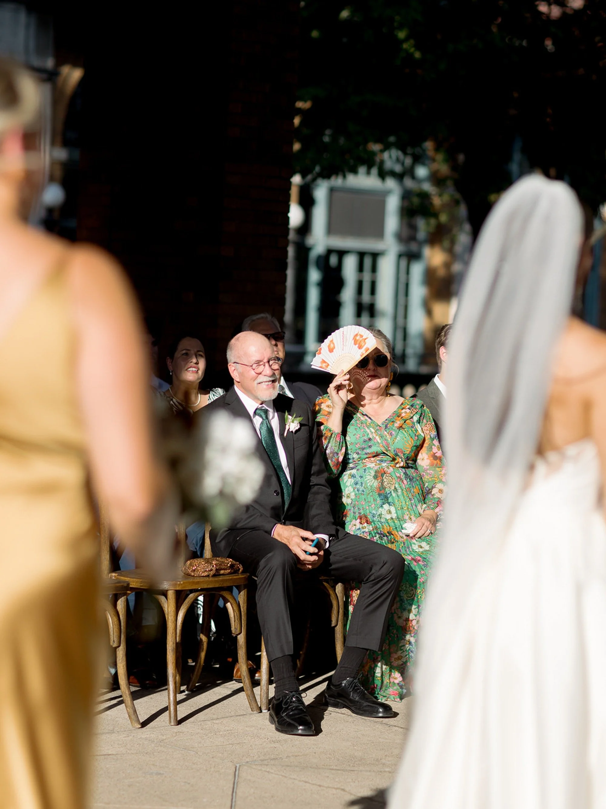 Shot over the veil — the father of the bride in the front row, watching his daughter say her vows, his expression a quiet mix of pride and emotion. One of the most genuine frames from this Columbus Park Refectory ceremony