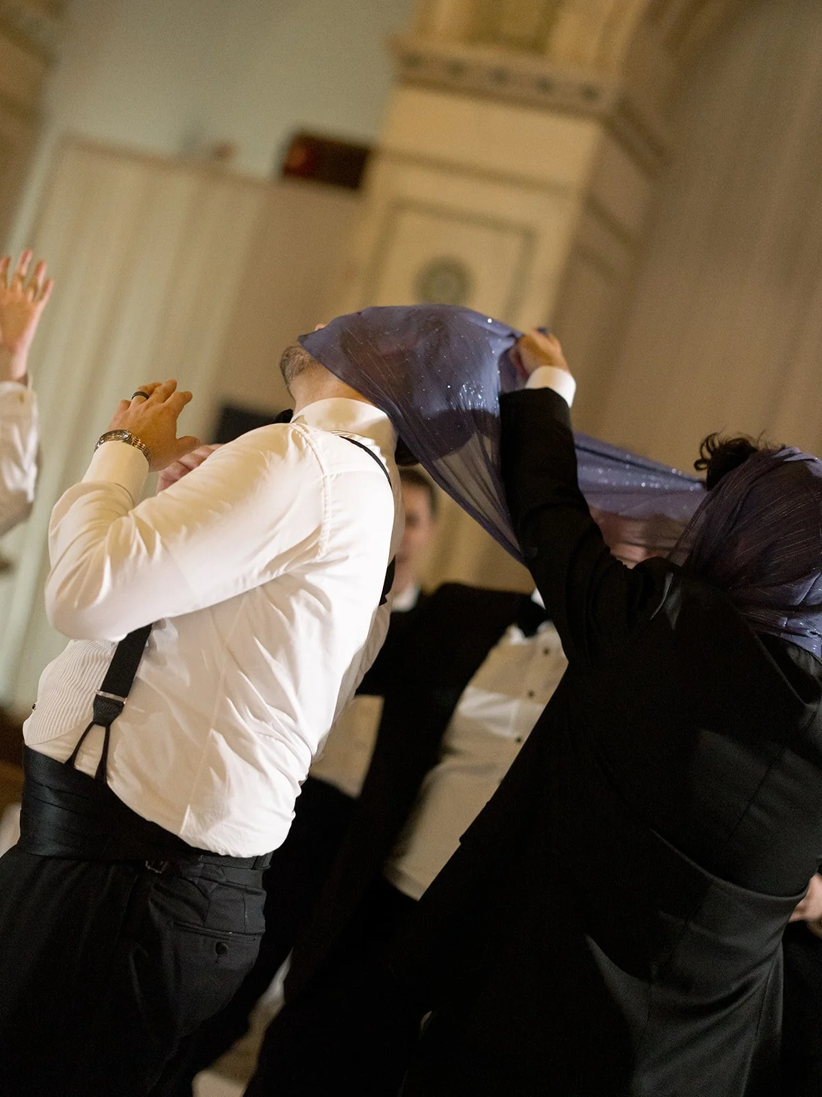 guests on the dance floor having a good time with a veil