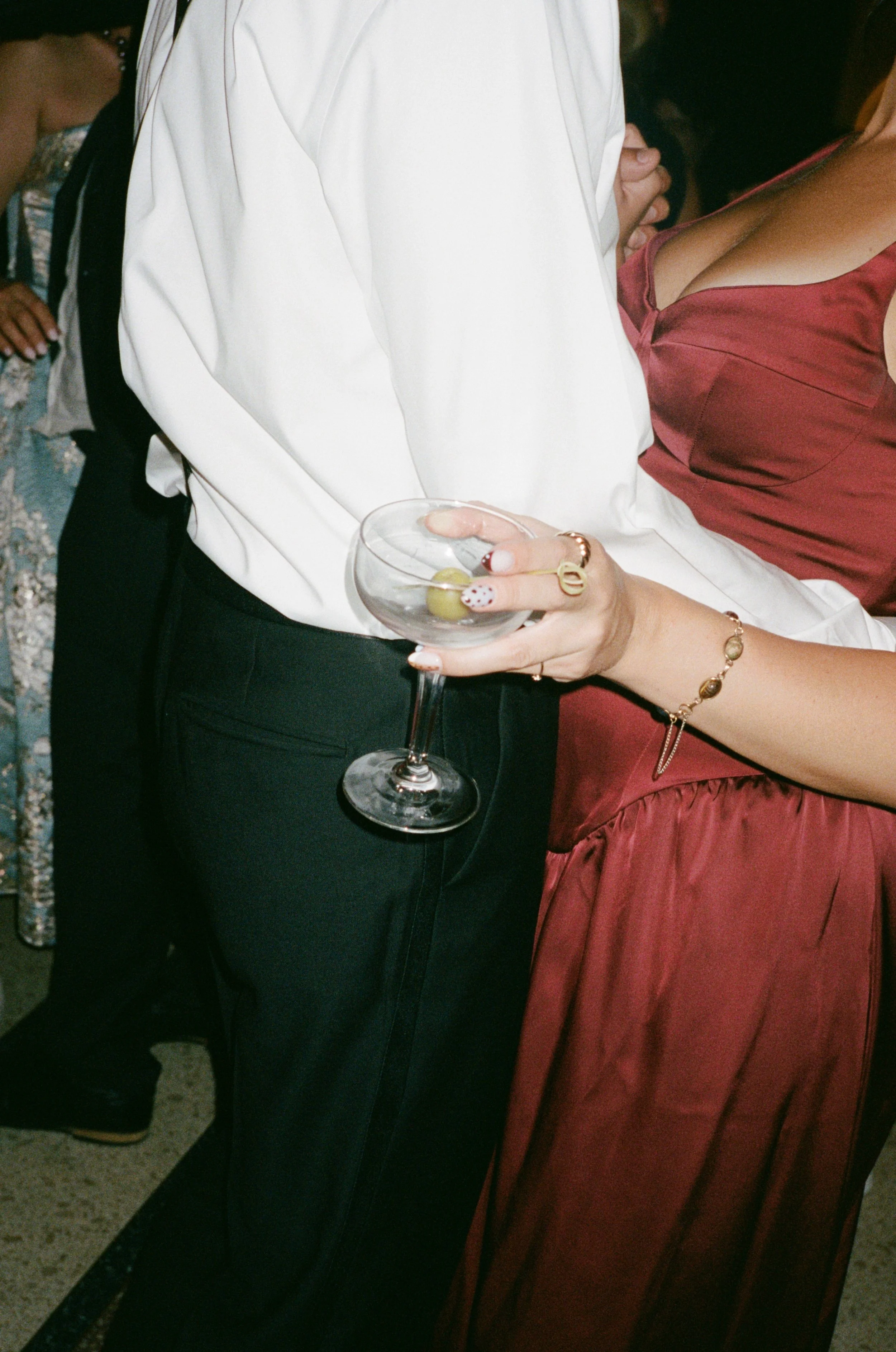 Close-up candid of guests holding a wine glass at the reception
