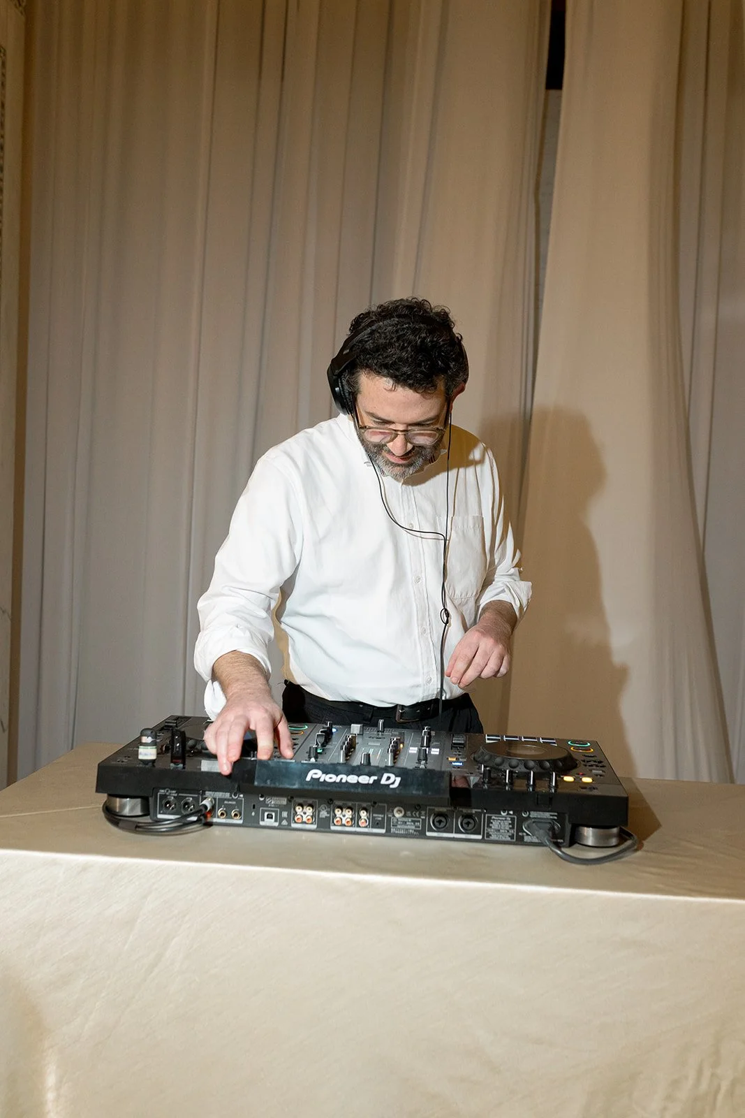 The DJ or musician performing at the reception, providing entertainment for the wedding guests throughout the evening. Shot on film by a Chicago wedding photographer.