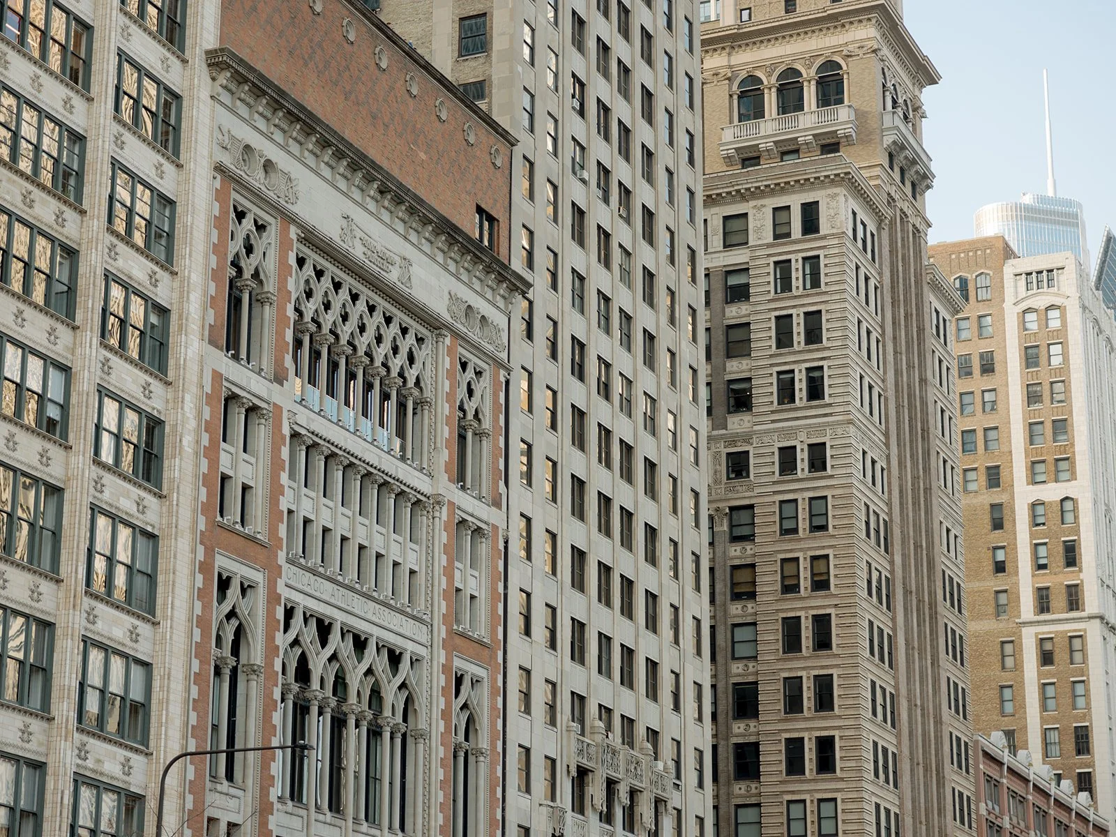 The historic stone and terracotta facades of downtown Chicago's landmark buildings, framed against a clear sky — the kind of architectural backdrop that makes every Chicago wedding feel significant.